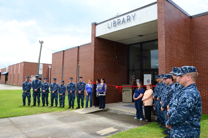 Sailors and staff members await the ribbon-cutting ceremony for the Weapons Station Branch Library May 7, 2013, at Joint Base Charleston – Weapons Station, S.C. Twenty-five Sailors helped move books, furniture and equipment from the library, saving the 628th Air Base Wing more than $90,000. (U.S. Air Force photo/Staff Sgt. Anthony Hyatt)