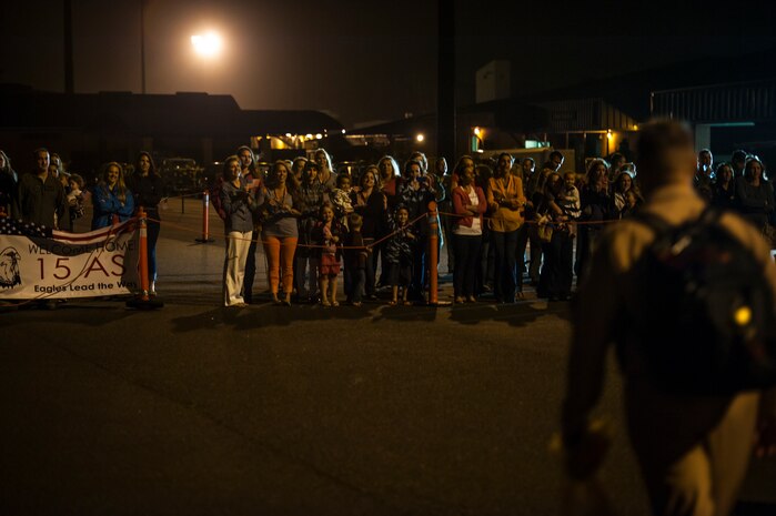 Family members of Airmen from the 15th Airlift Squadron wait in front of the 437th Airlift Wing Passenger Terminal for their Airmen to return home May 4, 2013, at Joint Base Charleston – Air Base, S.C. The squadron flew 1,000 sorties while safely moving 40 million pounds of cargo and 5,000 passengers throughout the area of responsibility. The squadron also precisely executed 33 combat airdrops resupplying forward operating bases throughout Southwest Asia with 900 bundles of supplies. (U.S. Air Force photo/ Senior Airman Dennis Sloan)
