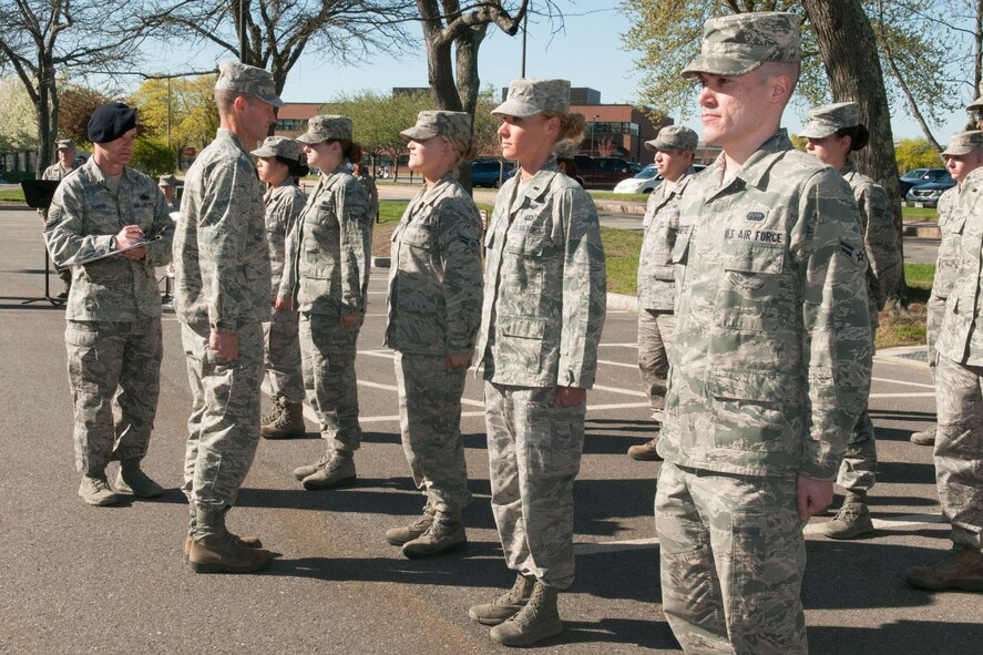 HANSCOM AIR FORCE BASE, Mass. - Maj. Gen. Craig Olson, Command, Control, Communications, Intelligence and Networks program executive officer, performs an inspection of troops prior to the monthly retreat ceremony outside Building 1606, May 1. First Lt. Mallory Morgan, front row, second from right, was recognized for having the “most outstanding military bearing and appearance.” (U.S. Air Force photo by Mark Herlihy)