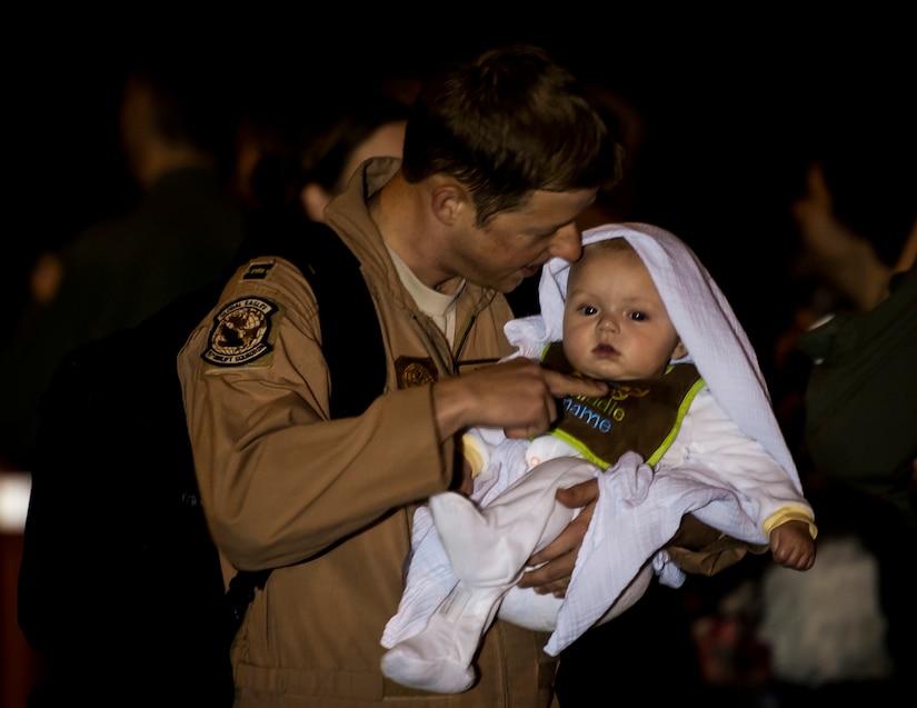 Capt. Kevin Vandagriff, 15th Airlift Squadron C-17 Globemaster III pilot, holds his 5--month old son Spencer May 4, 2013, at Joint Base Charleston – Air Base, S.C., after returning home from a two-month deployment to Southwest Asia. The squadron flew 1,000 sorties while safely moving 40 million pounds of cargo and 5,000 passengers throughout the area of responsibility. The squadron also precisely executed 33 combat airdrops resupplying forward operating bases throughout Southwest Asia with 900 bundles of supplies. (U.S. Air Force photo/ Senior Airman Dennis Sloan)