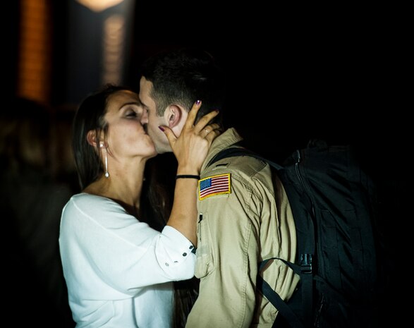 1st Lt. Jordan Novotny, 15th Airlift Squadron C-17 Globemaster III pilot, kisses his wife Rebecca May 4, 2013, at Joint Base Charleston – Air Base, S.C., after returning home from a two-month deployment to Southwest Asia. The squadron flew 1,000 sorties while safely moving 40 million pounds of cargo and 5,000 passengers throughout the area of responsibility. The squadron also precisely executed 33 combat airdrops resupplying forward operating bases throughout Southwest Asia with 900 bundles of supplies. (U.S. Air Force photo/ Senior Airman Dennis Sloan)