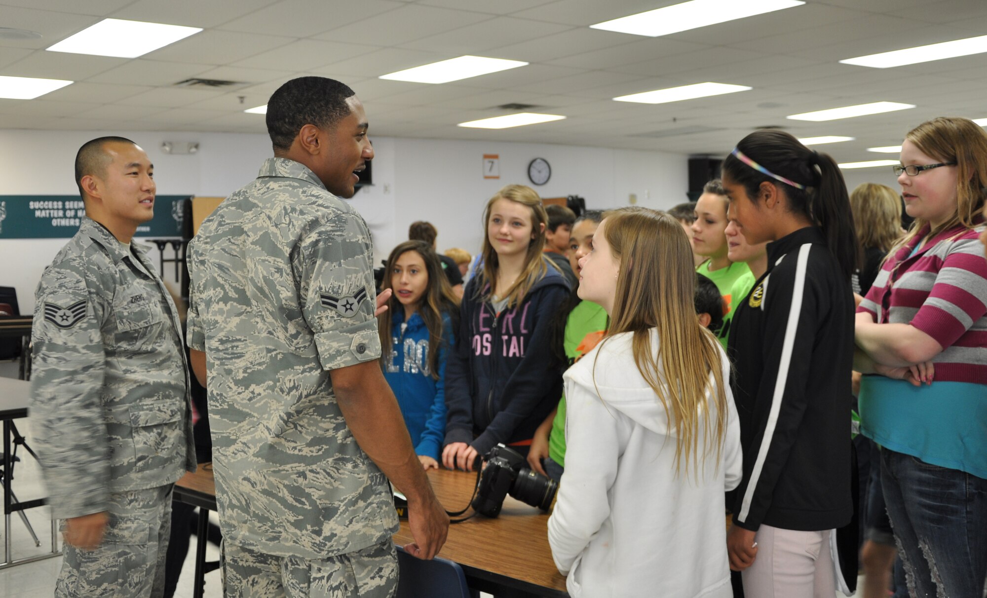 SAN ANGELO, Texas- Staff Sgt. David Zheng, 17th Training Wing broadcaster, and Airman 1st Class Michael Smith, 17th Training Wing photojournalist, talk to students about their careers in the U.S. Air Force at Glenn Middle School’s Career Day, May 3. Students asked questions about the Air Force and public affairs. (U.S. Air Force photo/ Airman 1st Class Erica Rodriguez)