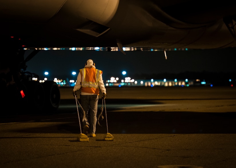 A civilian from the 437th Aircraft Maintenance Squadron prepares to  chalks  an aircraft May 4, 2013, at Joint Base Charleston – Air Base, S.C. The plane returned  Airmen from the 15th Airlift Squadron, to JB Charleston after a  two-month deployment to Southwest Asia. The squadron flew 1,000 sorties while safely moving 40 million pounds of cargo and 5,000 passengers throughout the area of responsibility. The squadron also precisely executed 33 combat airdrops resupplying forward operating bases throughout Southwest Asia with 900 bundles of supplies. (U.S. Air Force photo/ Senior Airman Dennis Sloan)