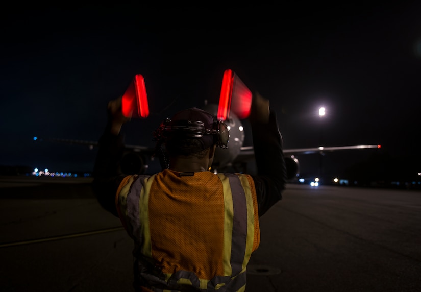 An aircraft carrying Airmen from the 15th Airlift Squadron, who are returning from a two-month deployment to Southwest Asia, is marshaled in May 4, 2013 at Joint Base Charleston – Air Base, S.C. The squadron flew 1,000 sorties while safely moving 40 million pounds of cargo and 5,000 passengers throughout the area of responsibility. The squadron also precisely executed 33 combat airdrops resupplying forward operating bases throughout Southwest Asia with 900 bundles of supplies. (U.S. Air Force photo/ Senior Airman Dennis Sloan)