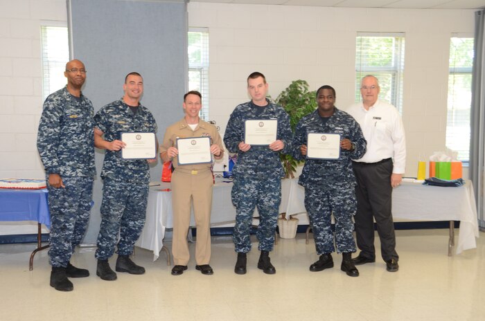 JOINT BASE CHARLESTON — WEAPONS STATION, S.C. —Naval Support Activity Charleston Executive Officer Cmdr. Marquis Patton (far left) and Navy-Marine Corps Relief Society Director David Hastings (far right) present certificates of appreciation to 2013 fund drive keyworkers, NSA Charleston Administrative Officer Lt. William Sever, NSA Charleston Command Master Chief Billy Cady, and Petty Officers 2nd Class Keith Rollinghoff and Ralph Palmer of Naval Munitions Command. The Charleston area NMCRS fund drive raised more than $100,000 to directly support active-duty Sailors and Marines, their families and retirees. (U.S. Navy photo/ Petty Officer 1st Class Chad Hallford)