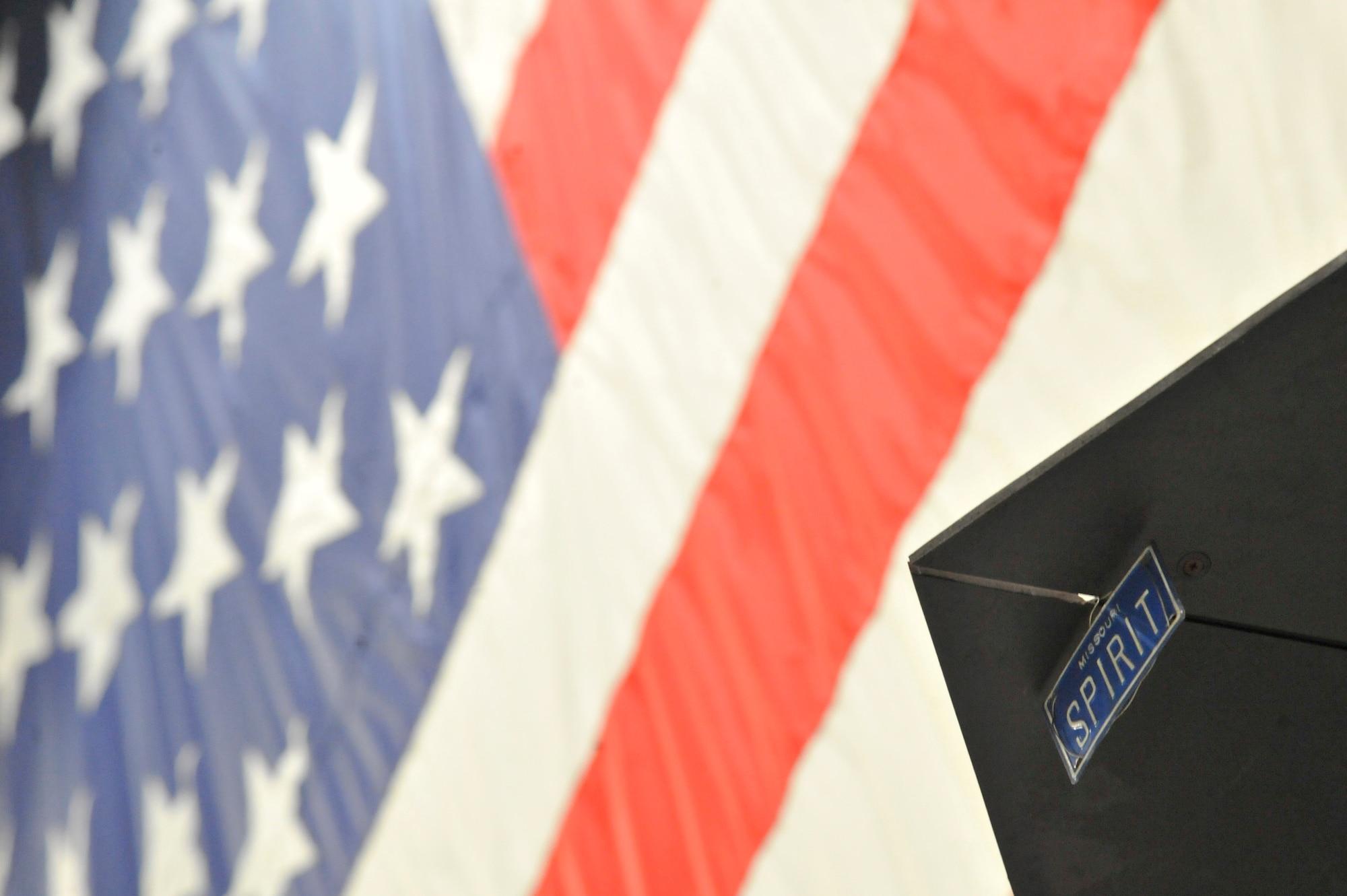 A ‘Spirit’ license plate hangs from the B-2 Spirit weapons load trainer at Whiteman Air Force Base, Mo., May 3, 2013. This model B-2 provides 509th Aircraft Maintenance Squadron load teams a realistic training platform that helps them prepare for real-world weapons loads should the B-2 be called upon to execute precision strikes anywhere in the world, and simultaneously removes the need to limit operational capability by employing an actual B-2 specifically for training purposes. (U.S. Air Force photo by Airman 1st Class Keenan Berry/Released)