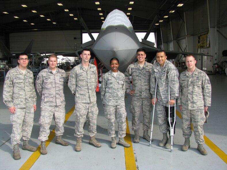 The F-22 Intelligence Initial Qualification Course Formal Training class posses for a photo in front of a F-22 Raptor static display. Each student received 196 academic hours consisting of classroom instruction, tours and labs conducted by F-22 subject matter experts, eight challenging exams and six practical exercises covering intelligence analysis, wartime briefing and combing intelligence debriefing/reporting. All of the students completed the five-week course, which will enable them to provide precise intelligence support to operational F-22 fighter squadrons throughout the combat air forces. (Courtesy photo) 
