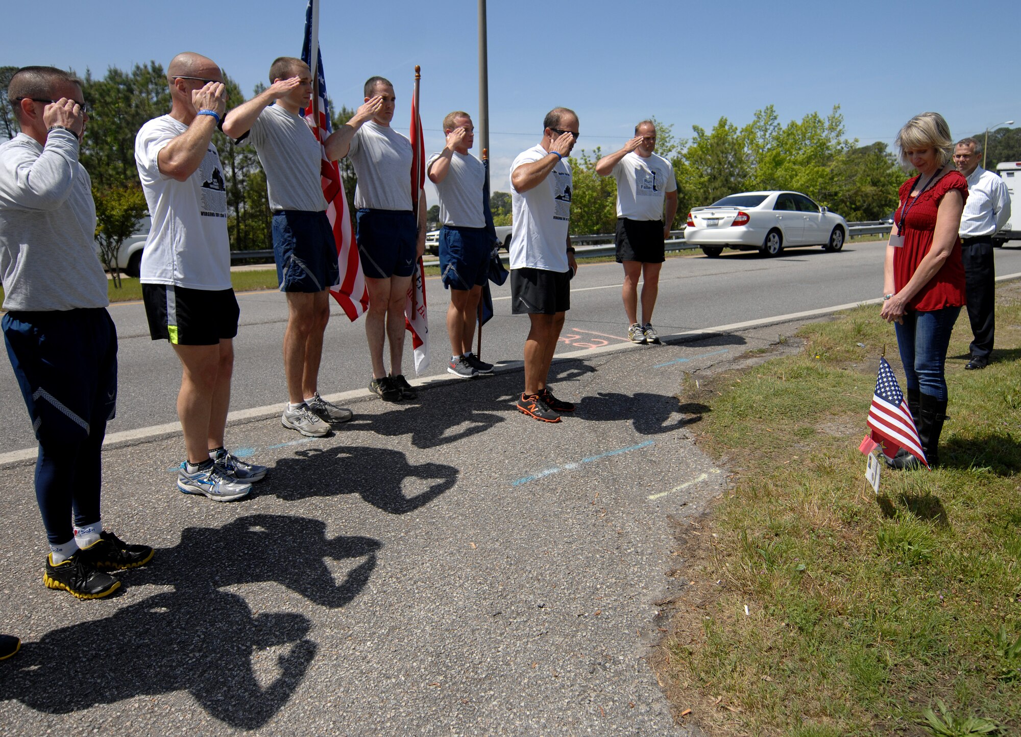 Runners salute the flag in honor of a fallen Service member during the “Run for the Fallen” event in Hampton Roads, Va., May 2, 2013. The Service members honored during this runs come from the local area and other parts of Virginia. (U.S. Air Force photo by Austin Harvill/Released)