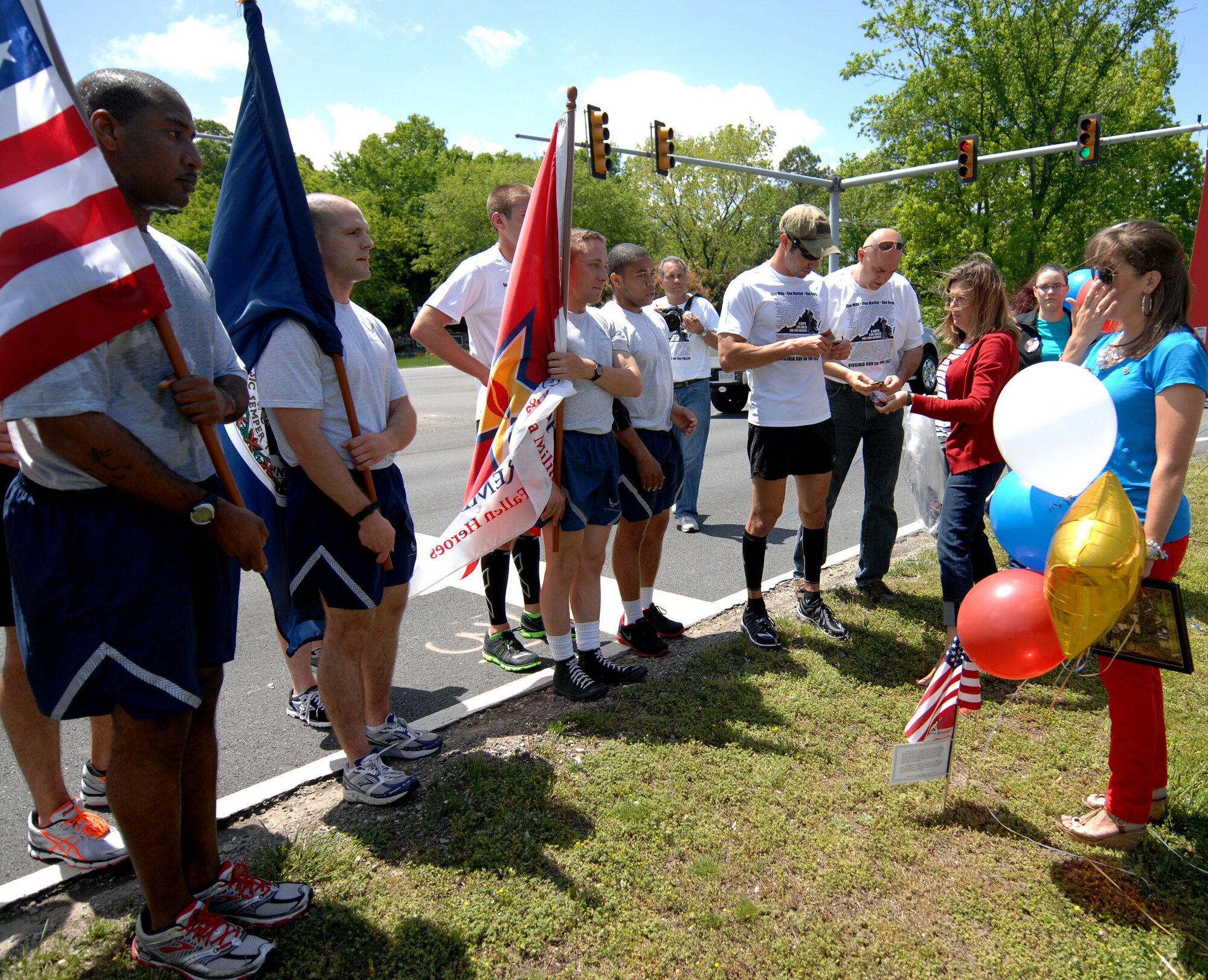 The wife of a fallen Service member wipes away her tears as runners read off his name during the “Run for the Fallen” event in Hampton Roads, Va., May 2, 2013. Although runners only promised to run three miles each, many ran more of the 15-mile stretch to show support to more families. (U.S. Air Force photo by Austin Harvill/Released)