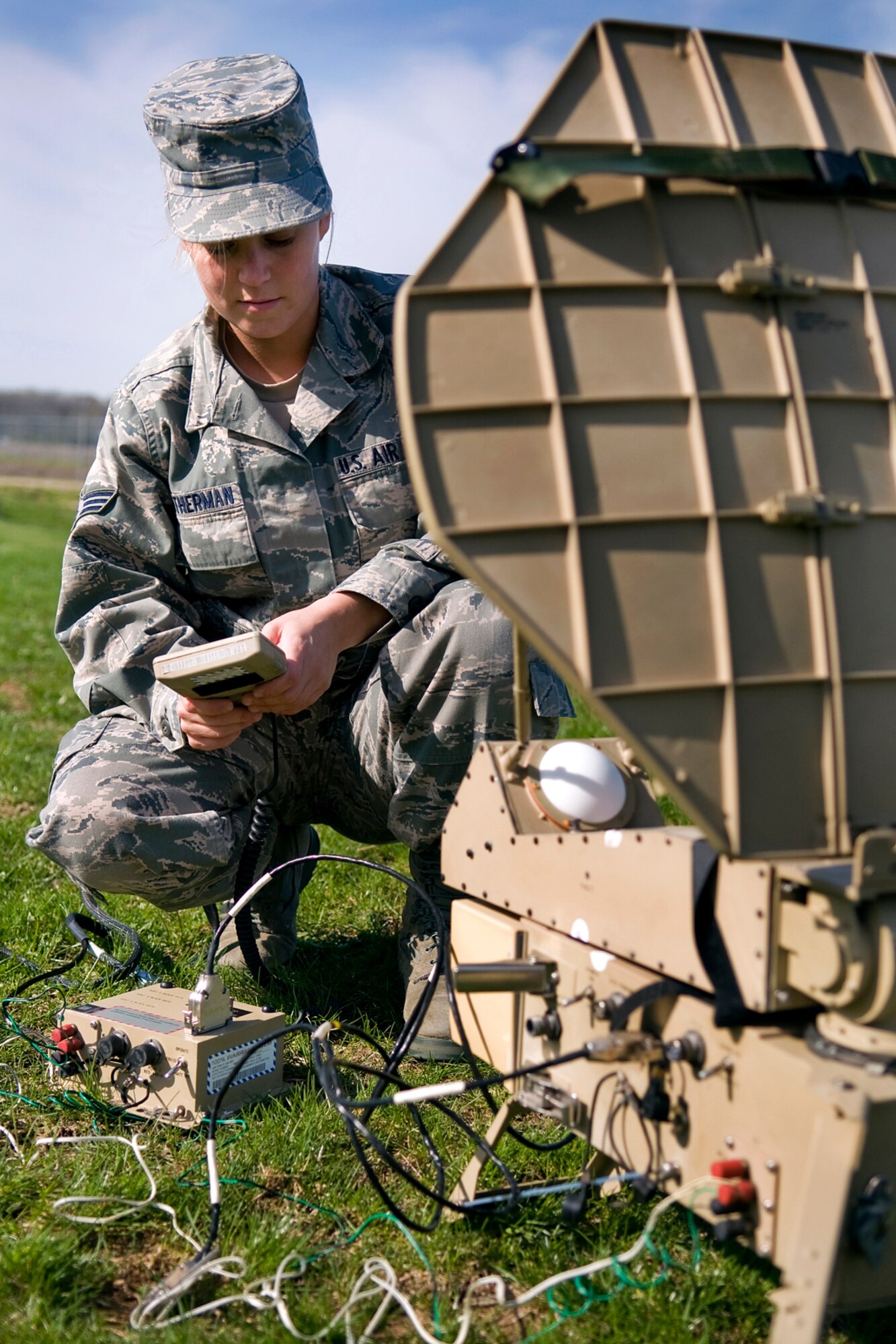 GRISSOM AIR RESERVE BASE, Ind. -- Senior Airman Jessica Weatherman, 434th Air Refueling Wing command and control technician, sets up an electromagnetic pulse and jam-resistant portable satellite communications terminal that connects with the Military Strategic and Tactical Relay satellite system here April 26. Grissom command post controllers use a myriad of high-tech equipment, which provide secure communications that allow command and control functions to continue in the event of a major disaster that could hinder communications. (U.S. Air Force photo/Tech. Sgt. Mark R. W. Orders-Woempner)