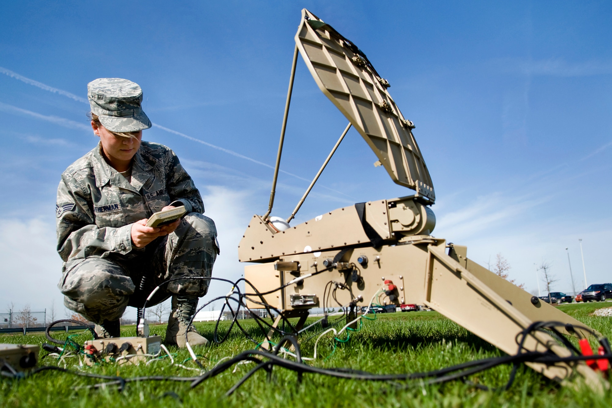 GRISSOM AIR RESERVE BASE, Ind. -- Senior Airman Jessica Weatherman, 434th Air Refueling Wing command and control technician, sets up an electromagnetic pulse and jam-resistant portable satellite communications terminal that connects with the Military Strategic and Tactical Relay satellite system here April 26. Grissom command post controllers use a myriad of high-tech equipment, which provide secure communications that allow command and control functions to continue in the event of a major disaster that could hinder communications. (U.S. Air Force photo/Tech. Sgt. Mark R. W. Orders-Woempner)