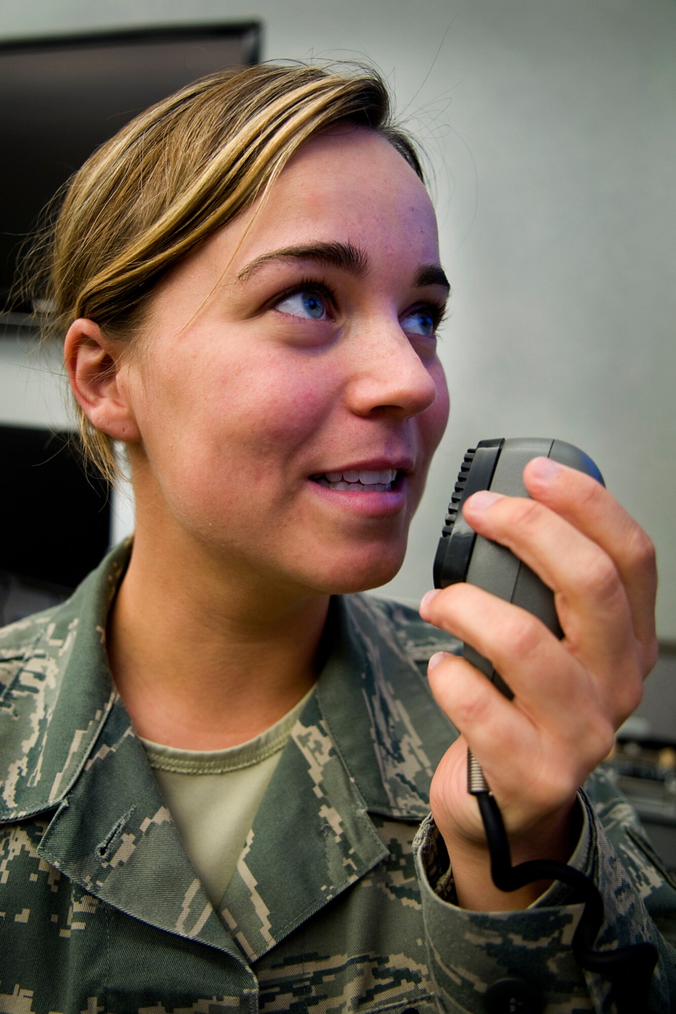 GRISSOM AIR RESERVE BASE, Ind. -- Senior Airman Jessica Weatherman, 434th Air Refueling Wing command and control technician, uses a base emergency notification system, often referred to as giant voice, here April 14. Command post controllers must be proficient in four core functions, which include tracking aircraft, reporting critical incidents, emergency notification and message processing. (U.S. Air Force photo/Tech. Sgt. Mark R. W. Orders-Woempner)
