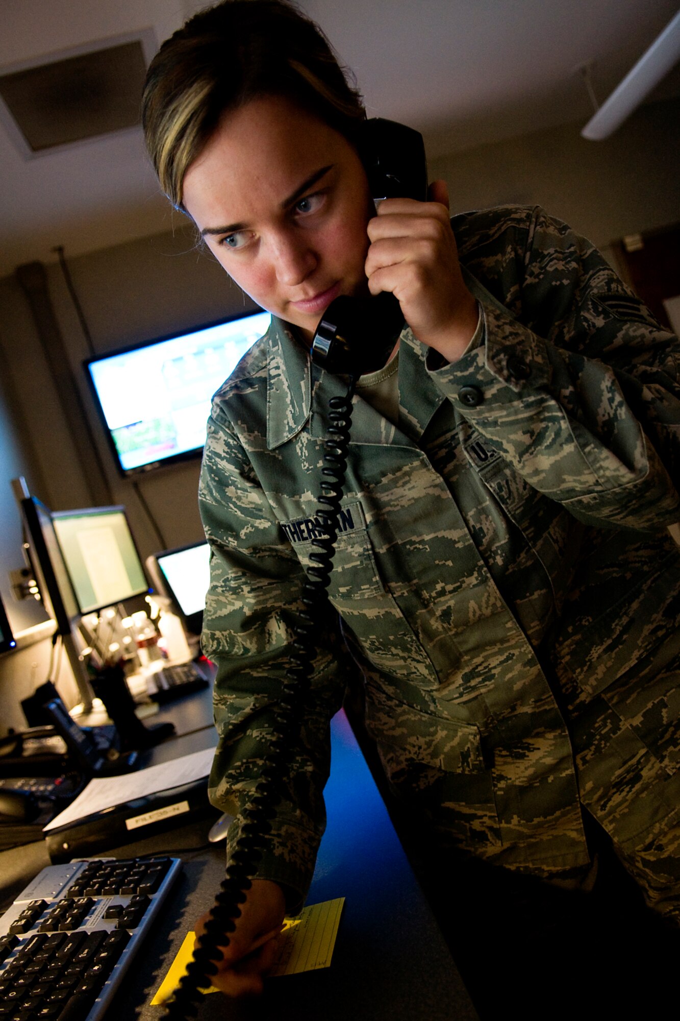 GRISSOM AIR RESERVE BASE, Ind. -- Senior Airman Jessica Weatherman, 434th Air Refueling Wing command and control technician, answers a call in the command post here April 14. The Grissom command post acts as a nerve center for the base and provides information from the field to the 434th ARW commander and vice versa. (U.S. Air Force photo/Tech. Sgt. Mark R. W. Orders-Woempner)
