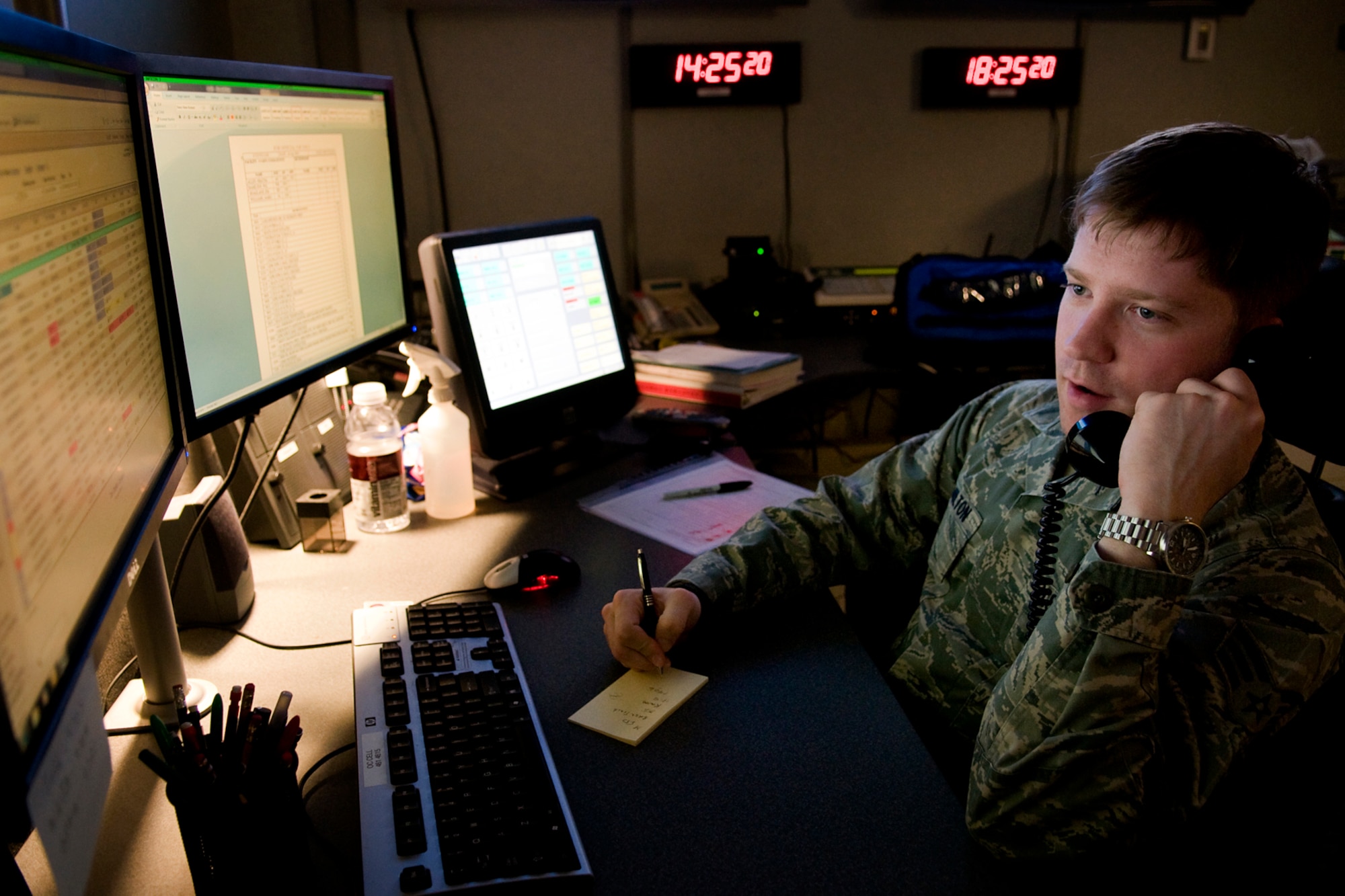 GRISSOM AIR RESERVE BASE, Ind. -- Senior Airman William Hamilton, 434th Air Refueling Wing command and control technician, discusses flight schedules with Grissom's base operations in the command post April 14. Command post controllers monitor and track all Grissom flights. (U.S. Air Force photo/Tech. Sgt. Mark R. W. Orders-Woempner)
