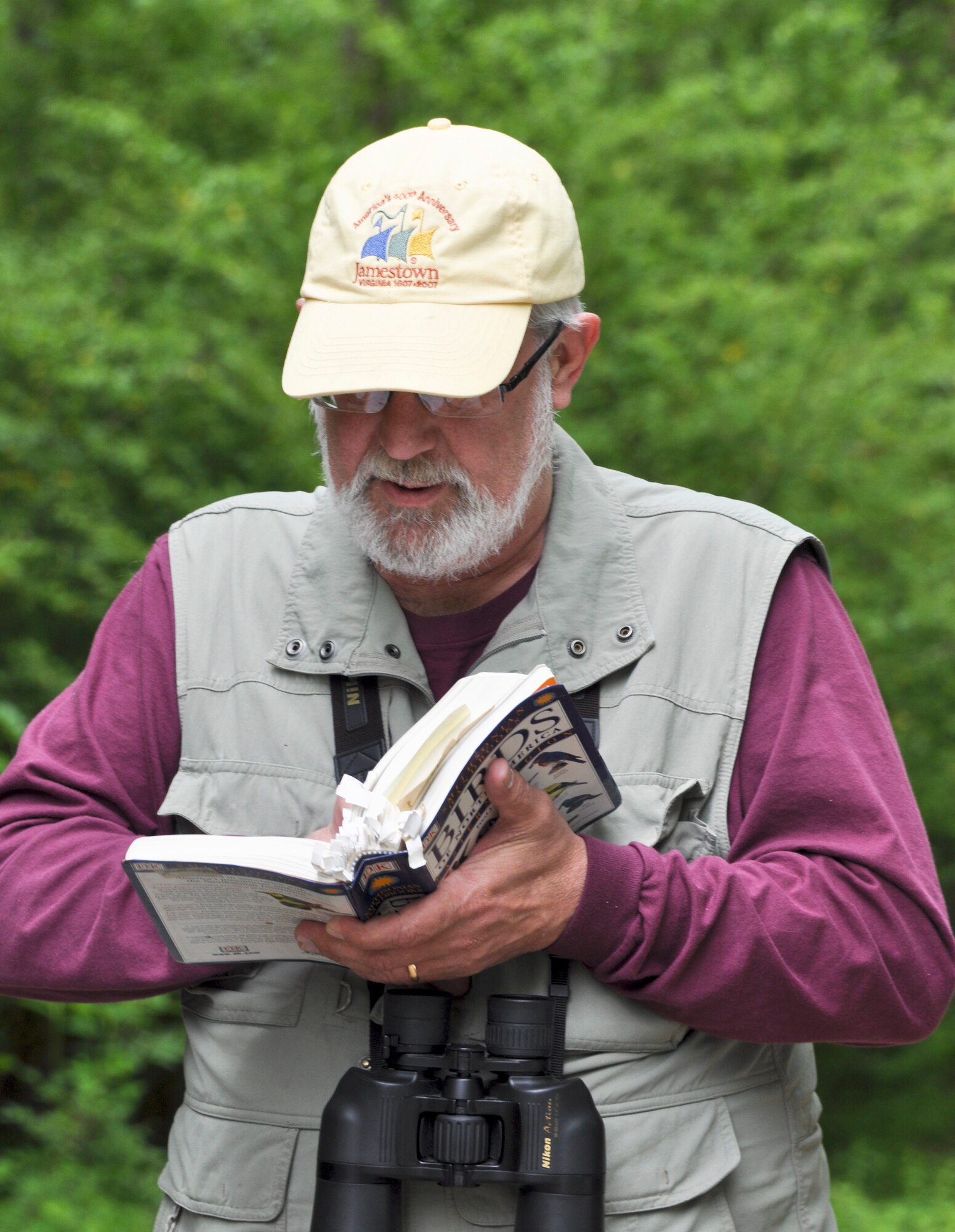 Vic Johnston, avid birder and 633rd Air Base Wing public affairs community relations chief, looks up information in a bird guide during Annual Spring Bird Count, May 4, 2013 at Langley Air Force Base, Va.  Johnston was one of two birders that conducted the count, cataloging 62 species and counting a total of 761 birds. (U.S. Air Force photo by Tech. Sgt. April Wickes/Released)