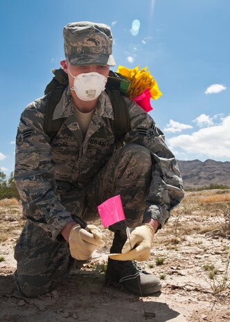 Senior Airman Travis Michel, 99th Force Support Squadron assignments counselor and casualty search and recovery team member, tags a bolt from a simulated C-17 Globemaster III crash May 6, 2013, during a Nellis Air Force Base, Nev., Casualty Search and Recovery Exercise. The 99th FSS hosted the exercise to test the team’s ability to properly respond an aircraft mishap in the Nevada desert. (U.S. Air Force photo by Staff Sgt. Michael Charles)