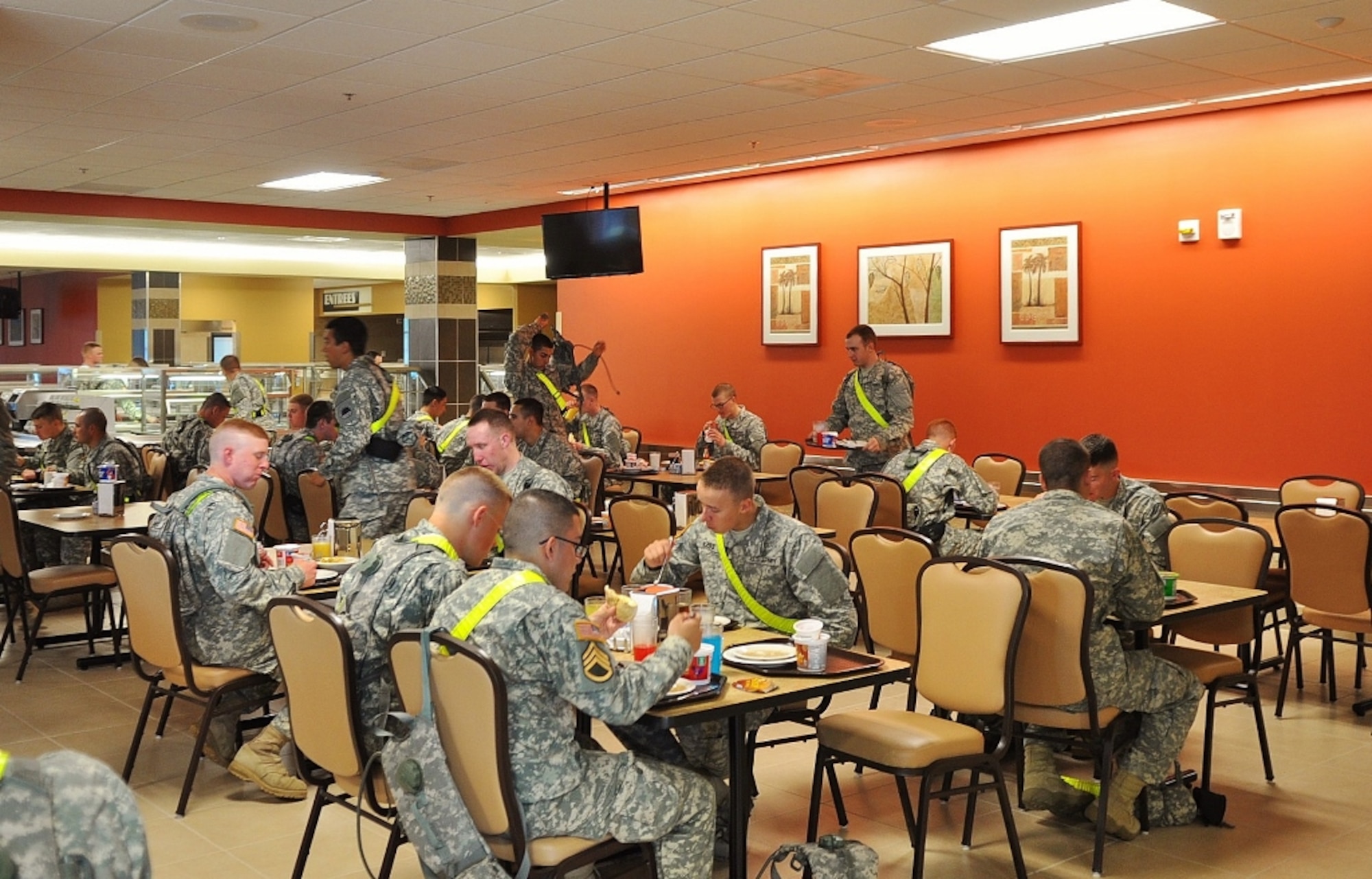 Soldiers enjoy lunch at the 733rd Logistics Readiness Division's “Warrior's Cafe” dining facility at Fort Eustis, Va., May 1, 2013. The new DFAC replaces three 1950's and 1960's-era facilities that had exceeded their service expectancy, providing a state-of-the-art dining hall featuring abundant natural lighting, flat-panel televisions and contemporary aesthetics. (U.S. Air Force photo by Senior Airman Jason J. Brown/Released)