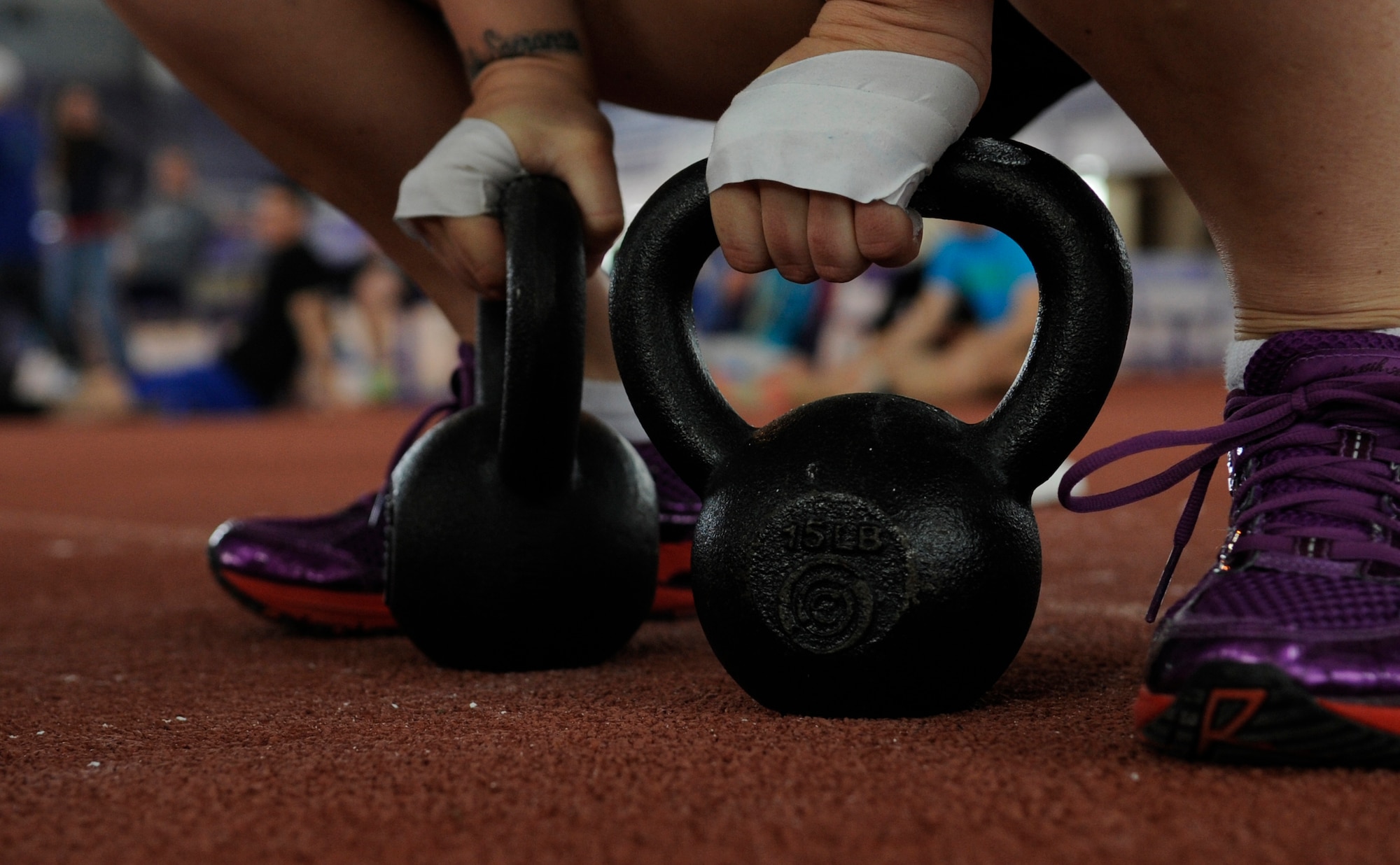 Staff Sgt. Samantha Scott, 509th Bomb Wing Command Post training manager, prepares to use kettle bells during the last event at the K-State CrossFit Challenge in Manhattan, Kan., April 27, 2013.  The event consisted of kettle bell squat clean thrusters, box jumping, an 800-meter run and deadlifts. (U.S. Air Force photo by Staff Sgt. Alexandra M. Boutte/Released)