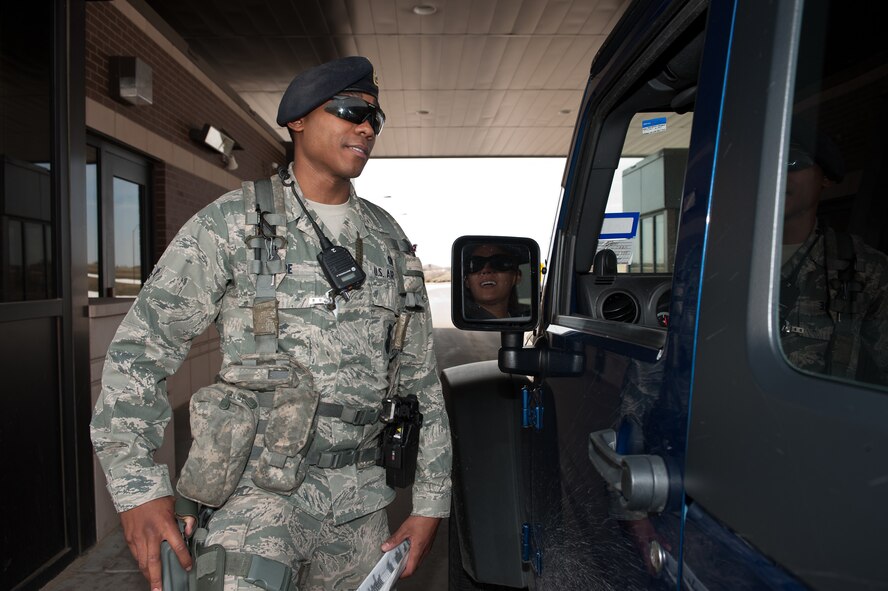 Airman Keith Leflore, 28th Security Forces Squadron defender, gives directions to a visitor after authorizing access at Ellsworth Air Force Base, S.D., April 25, 2013. 28th SFS defenders scan identification cards using DBIDS, which immediately reports if an individual is authorized entry to the base. (U.S. Air Force photo by Airman 1st Class Alystria Maurer/Released)  