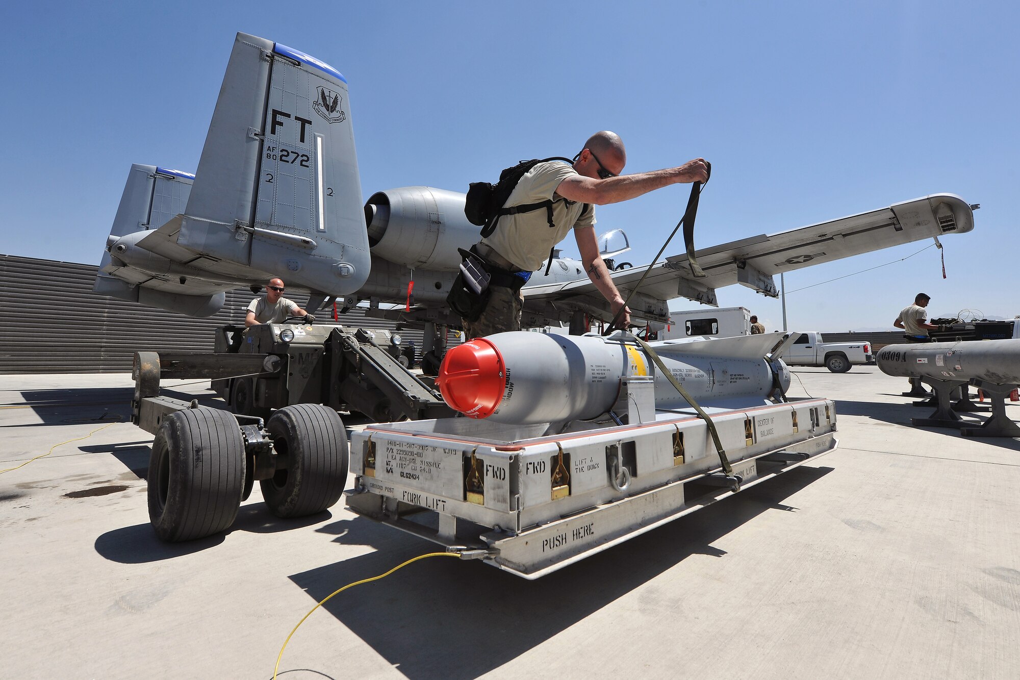 Weapon loaders from the 74th Expeditionary Fighter Squadron prepare to load ammunition onto an A-10 Thunderbolt II on Bagram Airfield, Afghanistan, May 8, 2013. The aircraft can deploy general purpose bombs, cluster bomb units, laser guided bombs, joint direct attack munitions, wind corrected munitions dispenser, AGM-65 Maverick and AIM-9 Sidewinder missiles, rockets, illumination flares, and the GAU-8/A 30mm cannon, capable of firing 3,900 rounds per minute.  (U.S. Air Force photo/Senior Airman Chris Willis)