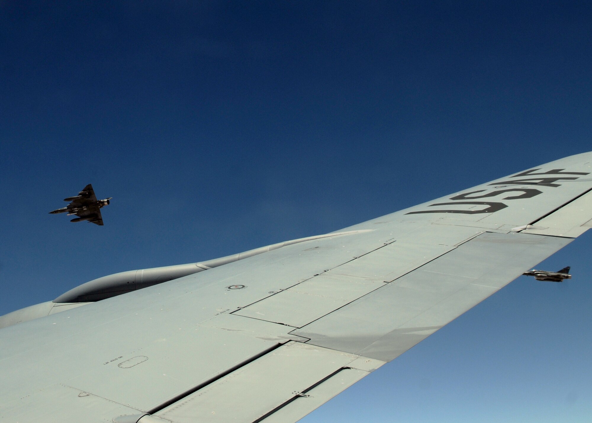 Two French Dassault Mirage F-1 fighter jets break formation with a KC-135R Stratotanker after refueling with the 351st Expeditionary Air Refueling Squadron May 3, 2013, over Mali. The 351st EARS recently flew its 200th mission in support of French-led operations May 5, 2013, after more than three months of aerial refueling sorties.  (U.S. Air Force photo by 1st Lt. Christopher Mesnard/Released)