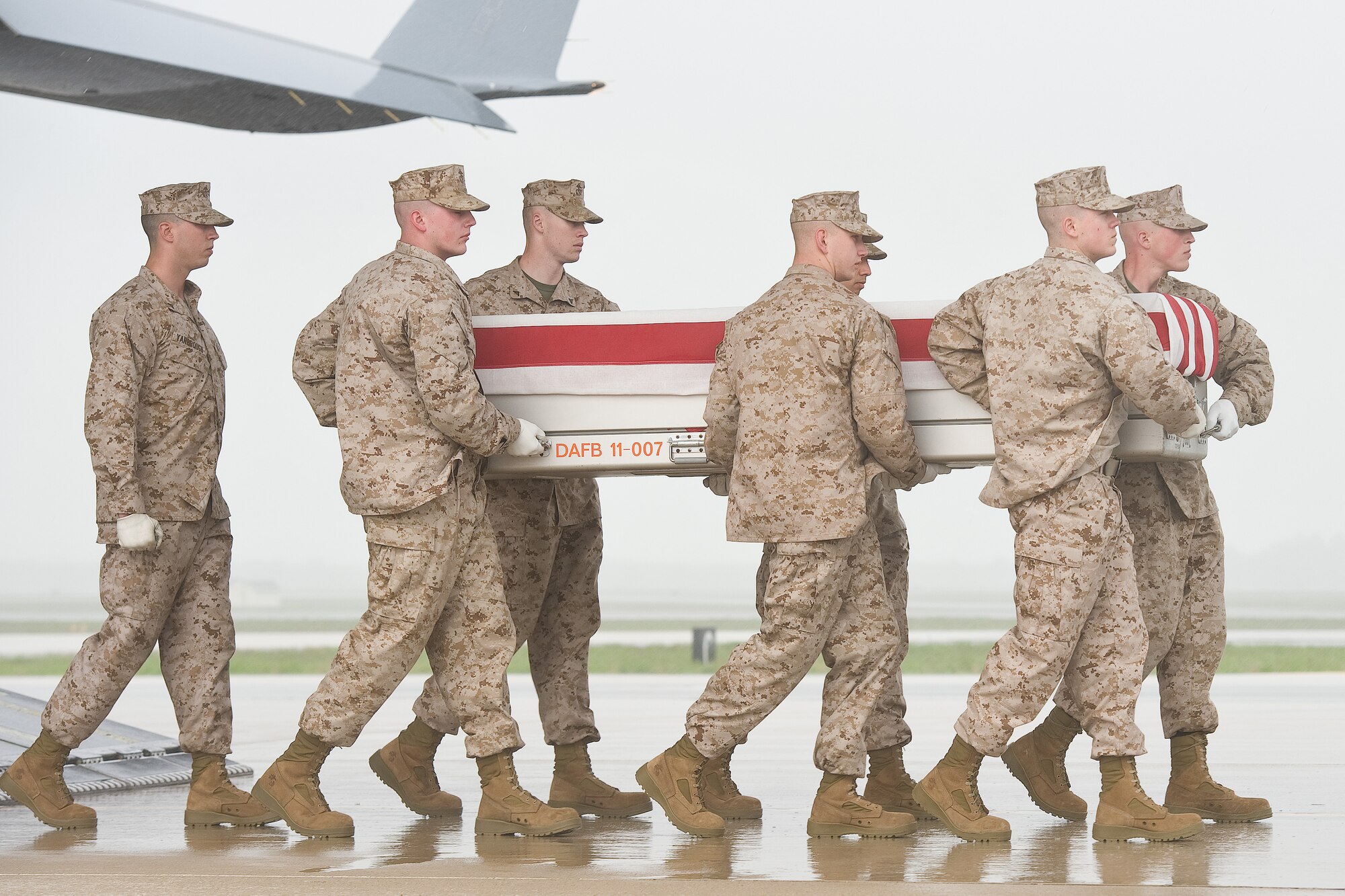 A U.S. Marine Corps carry team transfers the remains of Marine Staff Sgt. Eric D. Christian of Warwick, N.Y., at Dover Air Force Base, Del., May 7, 2013. Christian was assigned to 2nd Marine Special Operations Battalion, Camp Lejeune, N.C. (U.S. Air Force photo/Roland Balik)