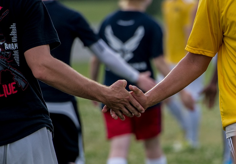 Members of 628th Logistics Readiness Squadron intramural soccer team shake hands with 437th Aerial Port Squadron intramural soccer team members May 2, 2013, at Joint Base Charleston – Air Base, S.C. The 628th LRS soccer team defeated the 437th APS soccer team 8 – 2 in Joint Base Charleston’s 2013 intramural soccer championship game. (U.S. Air Force photo/Staff Sgt. Rasheen Douglas)