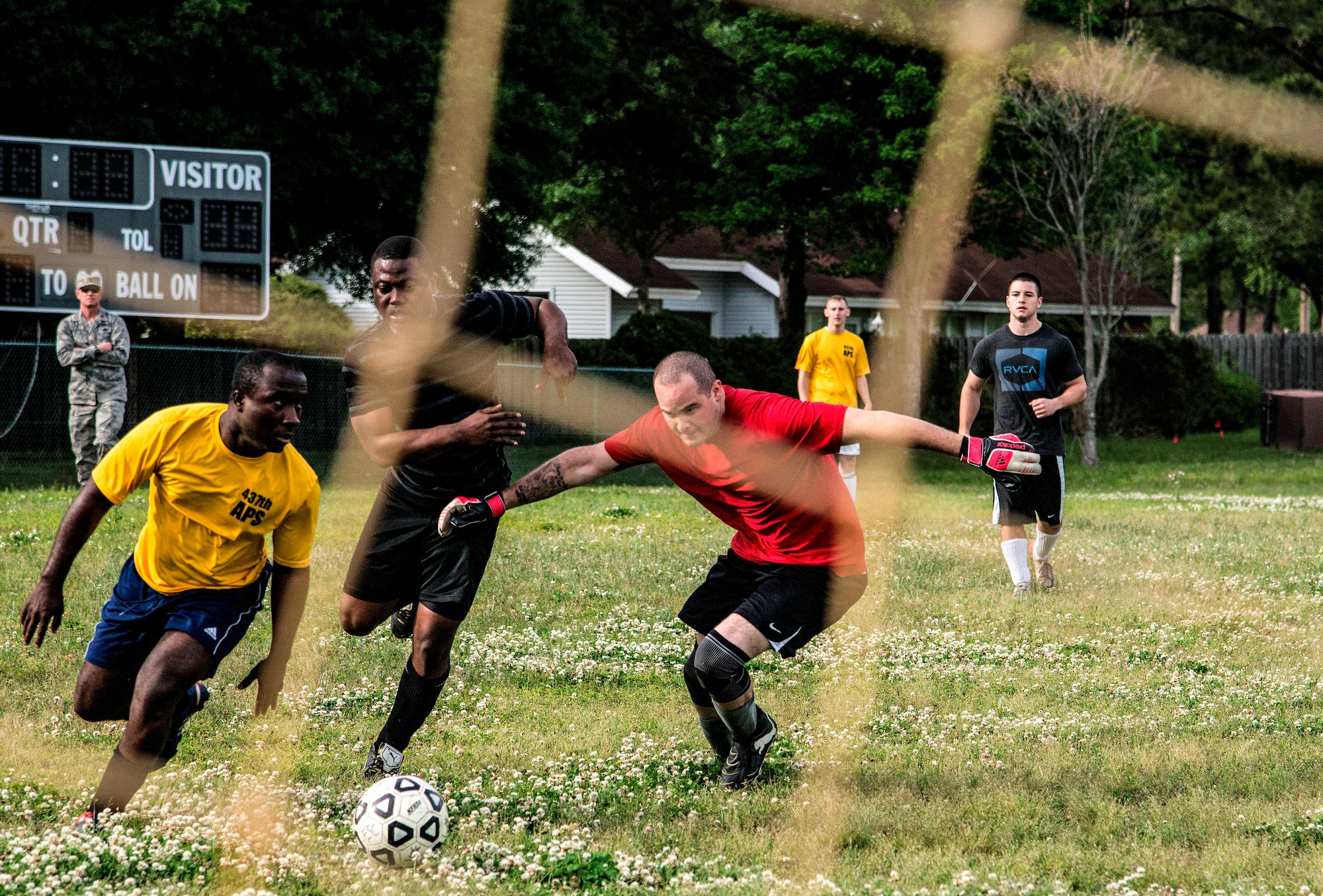 Senior Airman Michael Oheone (middle), 628th Logistics Readiness Squadron intramural soccer team player, attempts to get past Staff Sgt. Theophilus Okrah (left) and Senior Airman Ernest Love (right), 437th Aerial Port Squadron intramural soccer team defenders May 2, 2013, at Joint Base Charleston – Air Base, S.C.. The 628th LRS soccer team defeated the 437th APS soccer team 8 – 2 Joint Base Charleston’s 2013 intramural soccer championship game. (U.S. Air force photo/Staff Sgt. Rasheen Douglas)