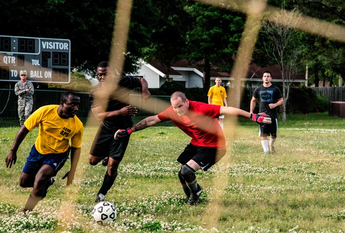 Senior Airman Michael Oheone (middle), 628th Logistics Readiness Squadron intramural soccer team player, attempts to get past Staff Sgt. Theophilus Okrah (left) and Senior Airman Ernest Love (right), 437th Aerial Port Squadron intramural soccer team defenders May 2, 2013, at Joint Base Charleston – Air Base, S.C.. The 628th LRS soccer team defeated the 437th APS soccer team 8 – 2 Joint Base Charleston’s 2013 intramural soccer championship game. (U.S. Air force photo/Staff Sgt. Rasheen Douglas)