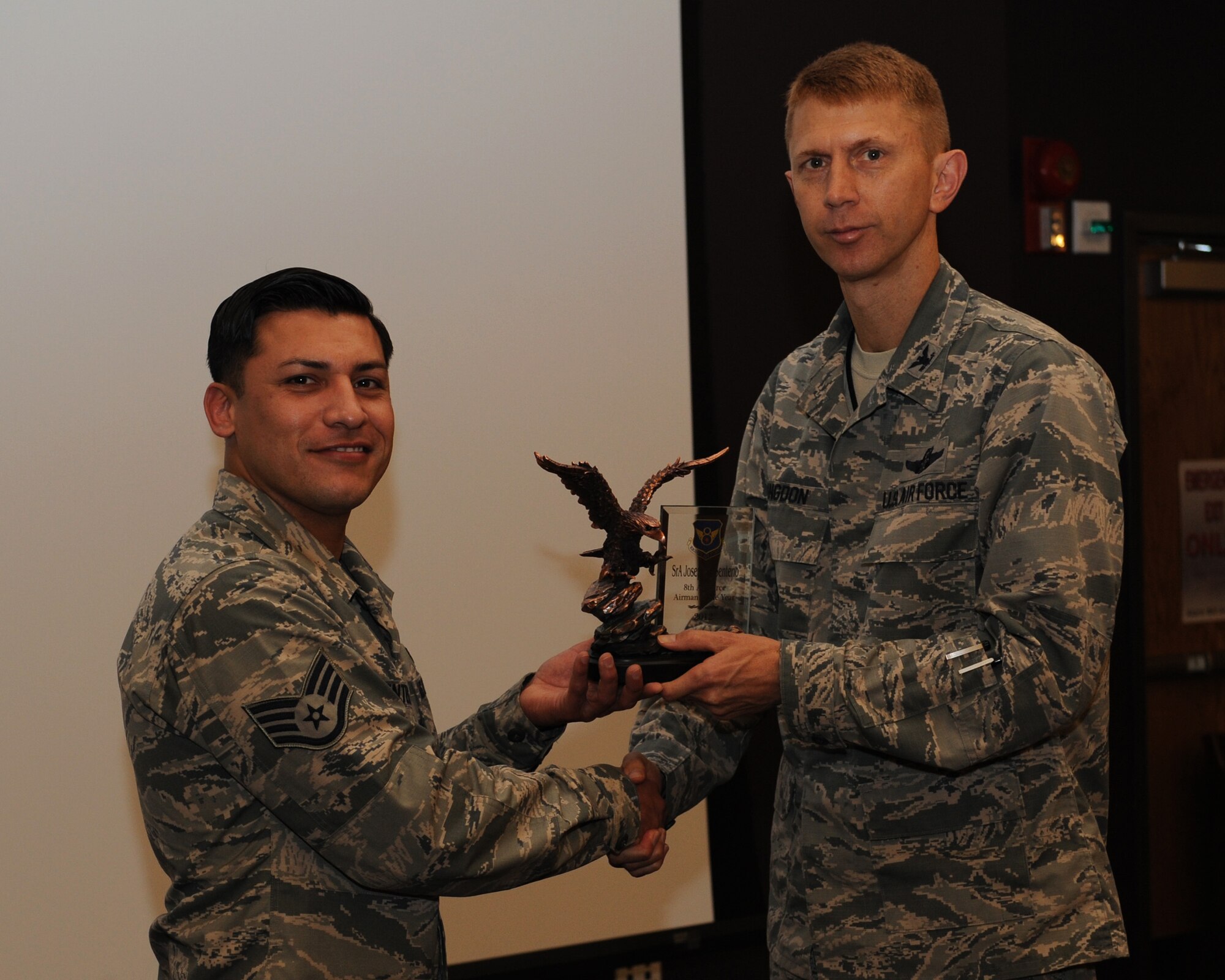 Staff Sgt. Joseph Senteno, 2nd Comptroller Squadron, receives the 8th Air Force Airman of the Year award for 2012 from Col. Reid Langdon, 2nd Bomb Wing vice commander, on Barksdale Air Force Base, La., May 8, 2013. (U.S. Air Force photo/Airman 1st Class Benjamin Gonsier)