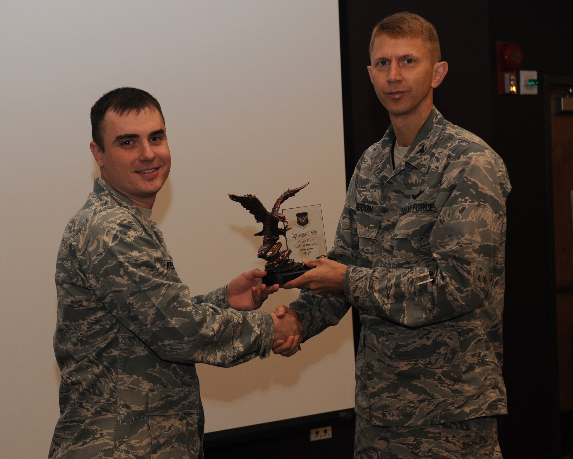 Capt. Douglas Kelley, 2nd Civil Engineer Squadron, receives the 8th Air Force CGO of the Year award for 2012 from Col. Reid Langdon, 2nd Bomb Wing vice commander, on Barksdale Air Force Base, La., May 8, 2013. (U.S. Air Force photo/Airman 1st Class Benjamin Gonsier)