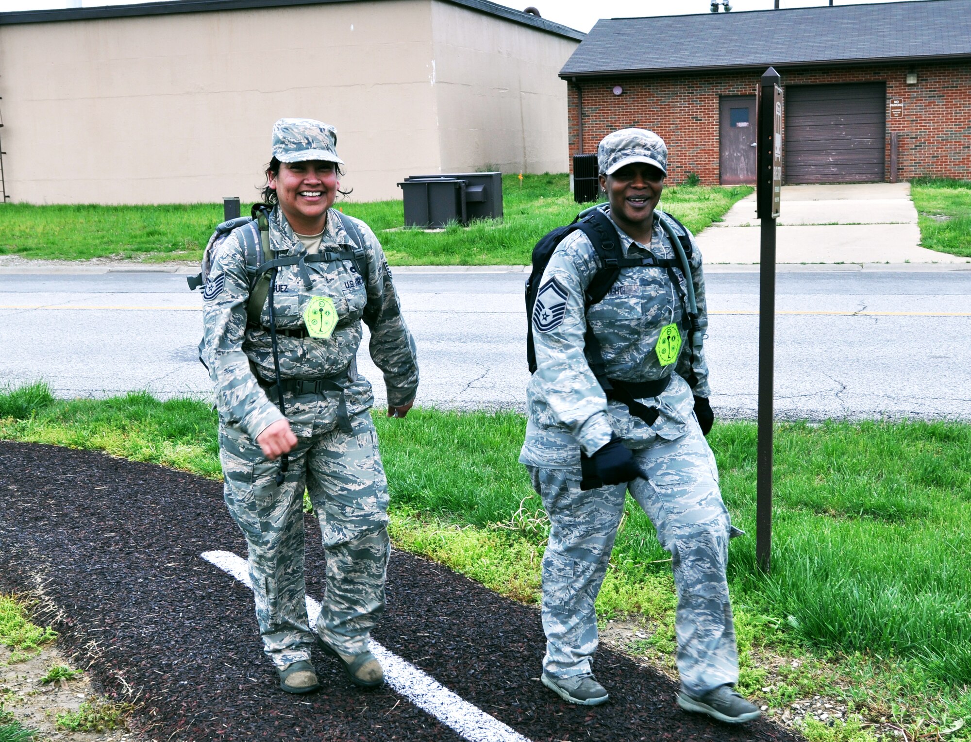 Two Airmen put on smiles and shout "girl power" to represent the few women that competed in the 2nd Annual Death March May 4, 2013. Their team was awarded the gold medal for the female division. (U.S. Air Force Photo by Airman Megan Friedl.)