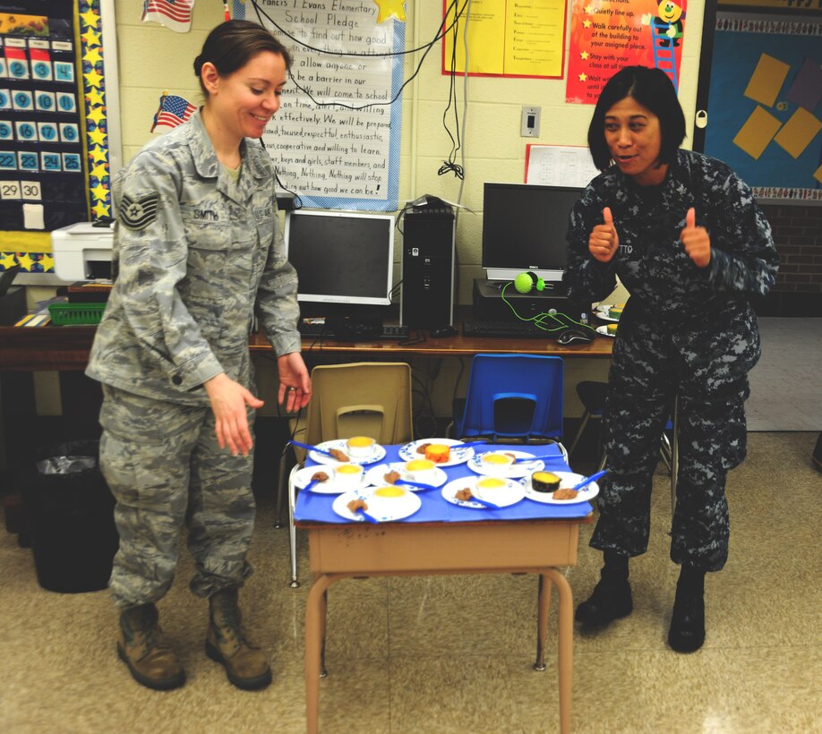 Joint Base Andrews, Md., Tech. Sgt. Danella Smith, 11th Civil Engineer Squadron dorm manger, and  Petty Officer 2nd Class Renelyn Barretto, Naval Support Activity Washington culinary specialist, bringsbring their talent for baking to a local elemetary school career day event, May 3, 2013. The children were allowed to decorate their own cupcakes after learning about the trade. (U.S. Air Force photo/Staff Sgt. Amber Russell)