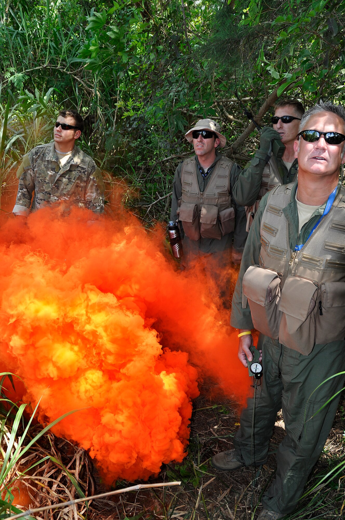 Staff Sgt. Ronnie Wheeler, left, Survival Evasion Resistance Escape Specialist, Special Operations Command South, instructs pilots from Homestead Air Reserve Base, Fla., on how to signal position for a ground rescue during survival training May 4. (U.S. Air Force photo/Staff Sgt. Lou Burton)