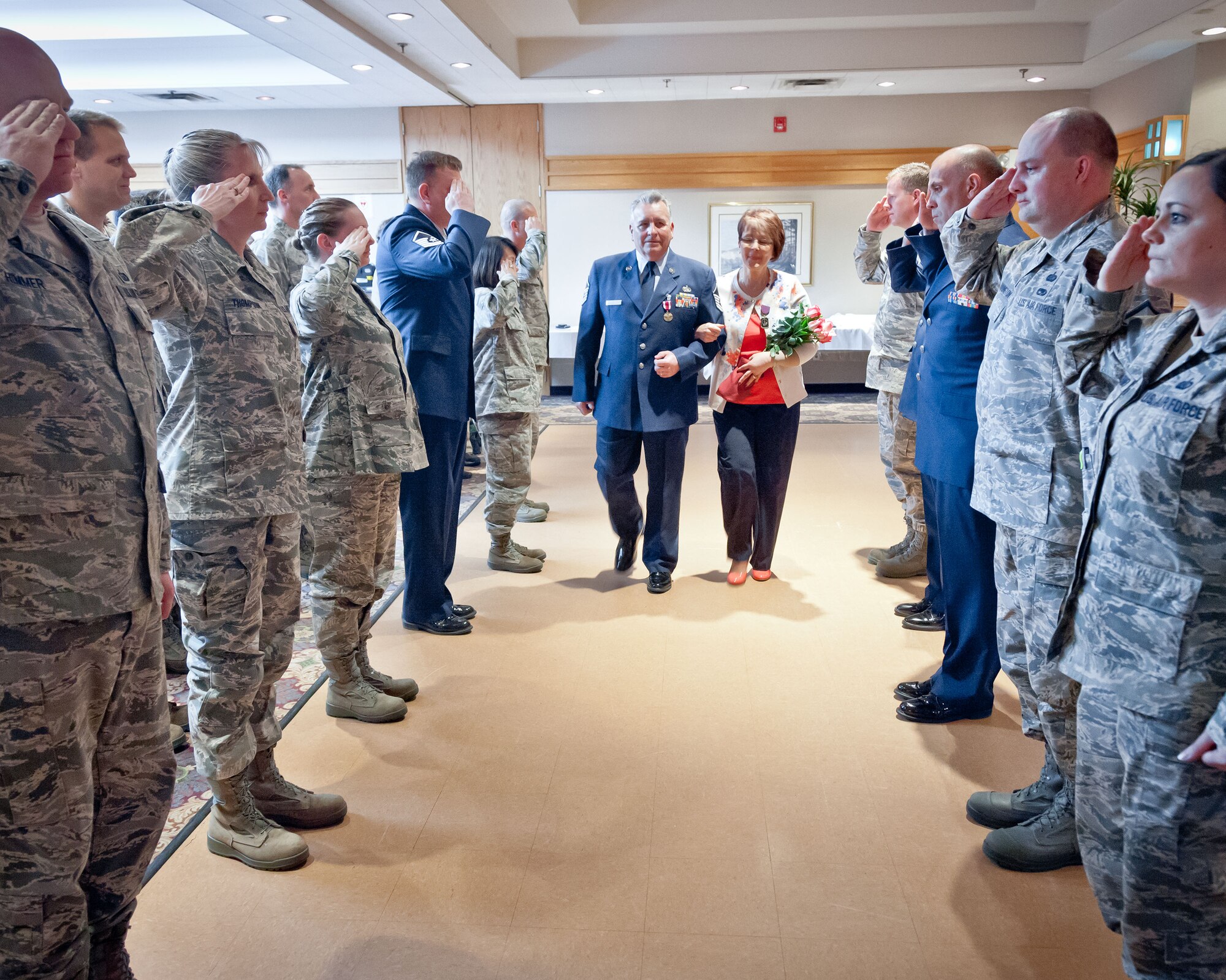 Master Sgt. Steven Gray, 934th Force Support Squadron, and his wife are piped ashore at his retirement ceremony; a Naval tradition, as he also served in the Navy before he joined the Air Force Reserve.  Sergean Gray retires after over 26 years of service during the May Unit Training Assembly weekend at Minneapolis-St. Paul Air Reserve Station, Minn.  (U.S. Air Force photo/Shannon McKay)