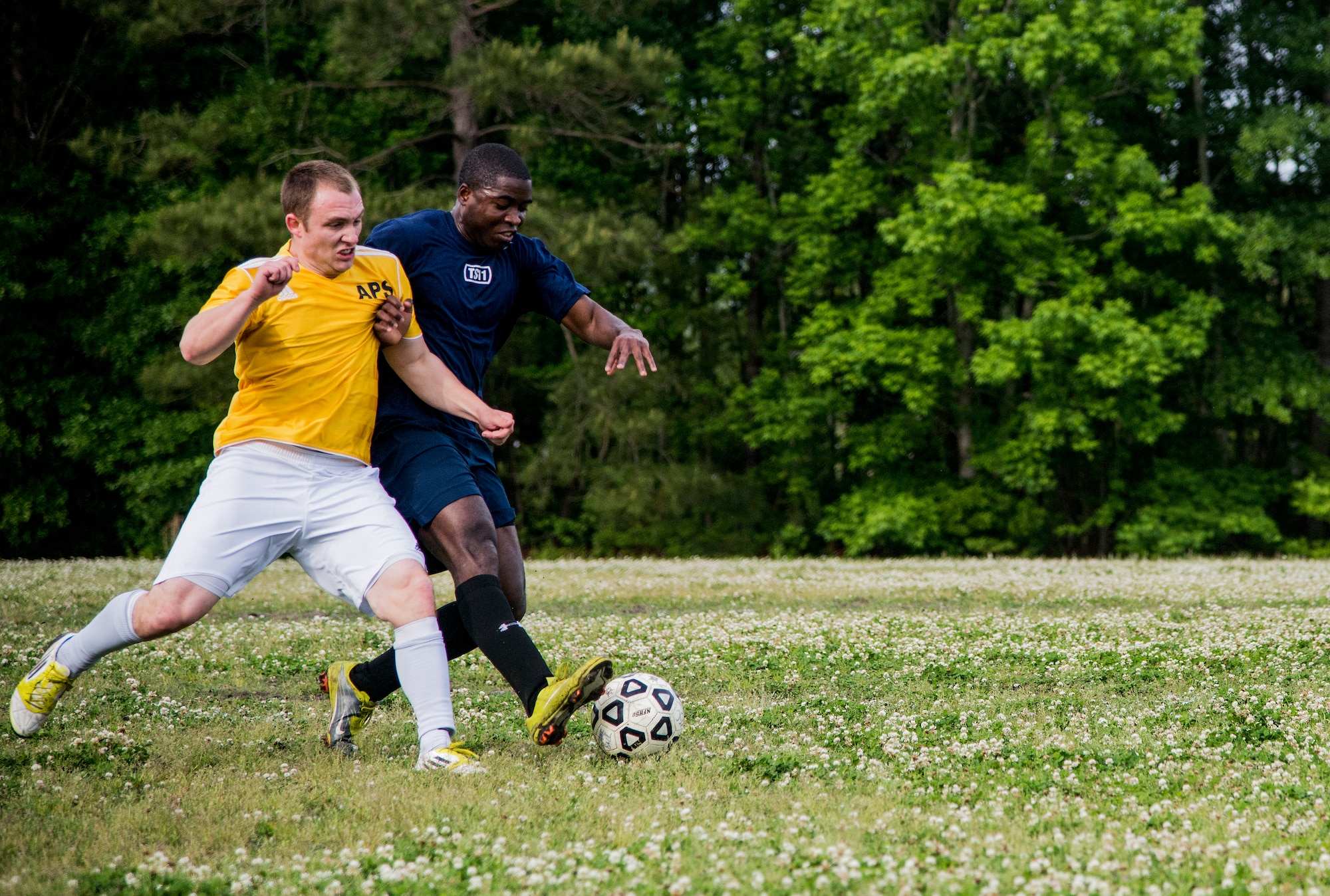 Airman 1st Class Kelvin Zelee (right), 628th Logistics Readiness Squadron intramural soccer team player, attempts to dribble past Senior Airman Jesse Ritz, 437th Aerial Port Squadron intramural soccer team defender May 2, 2013, at Joint Base Charleston – Air Base, S.C. The 628th LRS soccer team defeated the 437th APS soccer  team 8 – 2 in Joint Base Charleston’s 2013 intramural soccer championship game. (U.S. Air force photo/Staff Sgt. Rasheen Douglas)