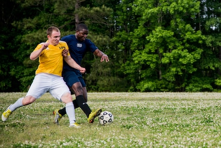 Airman 1st Class Kelvin Zelee (right), 628th Logistics Readiness Squadron intramural soccer team player, attempts to dribble past Senior Airman Jesse Ritz, 437th Aerial Port Squadron intramural soccer team defender May 2, 2013, at Joint Base Charleston – Air Base, S.C. The 628th LRS soccer team defeated the 437th APS soccer  team 8 – 2 in Joint Base Charleston’s 2013 intramural soccer championship game. (U.S. Air force photo/Staff Sgt. Rasheen Douglas)