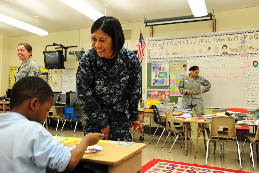 Petty Officer 2nd Class Renelyn Barretto, Joint Base Andrews, Md., Naval Support Activity Washington culinary specialist, brings her talent for baking to a local elemetary school career day event, May 3, 2013. The children were allowed to decorate their own cupcakes after learning about the trade. (U.S. Air Force photo/Staff Sgt. Amber Russell)