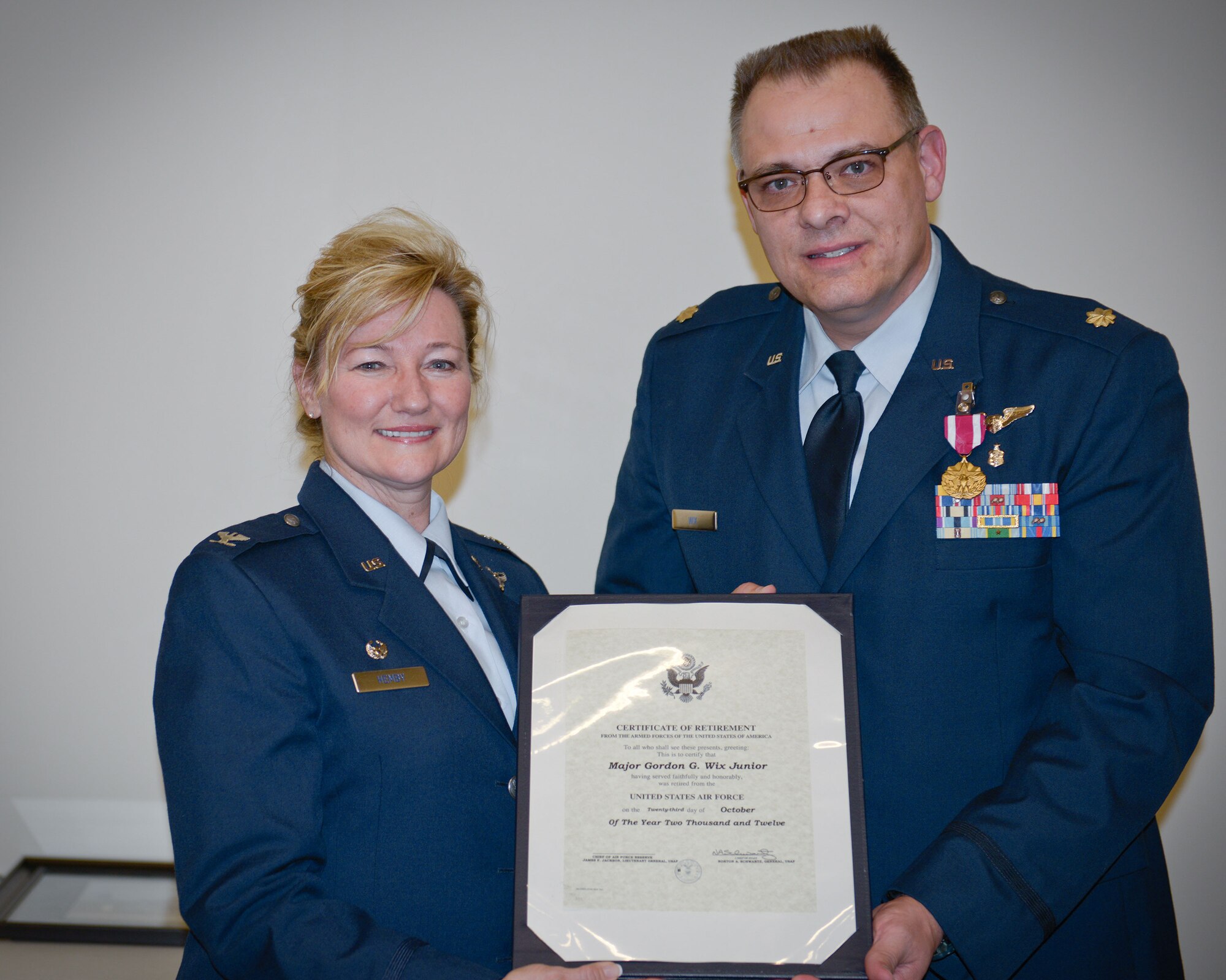 Col. Sherry Hemby, 934th Aeromedical Evacuation Squadron commander, presents Maj. Gordan Wix, Jr. with his certificate of retirement during the May Unit Training Assembly weekend at Minneapolis-St. Paul Air Reserve Station, Minn.  (U.S. Air Force photo/Paul Zadach)