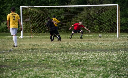 628th Logistics Readiness Squadron intramural soccer team scores a goal against Senior Airman Ernest Love, 437th Aerial Port Squadron intramural soccer team goalie May 2, 2013, at Joint Base Charleston – Air Base, S.C. The 628th LRS soccer team defeated the 437th APS soccer team 8 – 2 in Joint Base Charleston’s 2013 intramural soccer championship game. (U.S. Air force photo/Staff Sgt. Rasheen Douglas)