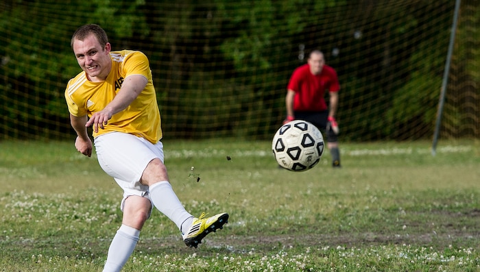 Senior Airman Jesse Ritz, 437th Aerial Port Squadron intramural soccer team player, dribbles past Master Sgt. Andred Jackson, 628th Logistics Readiness Squadron intramural soccer team defender May 2, 2013, at Joint Base Charleston – Air Base, S.C. The 628th LRS soccer team defeated the 437th APS soccer team 8 – 2 in Joint Base Charleston’s 2013 intramural soccer championship game. (U.S. Air force photo/Staff Sgt. Rasheen Douglas)