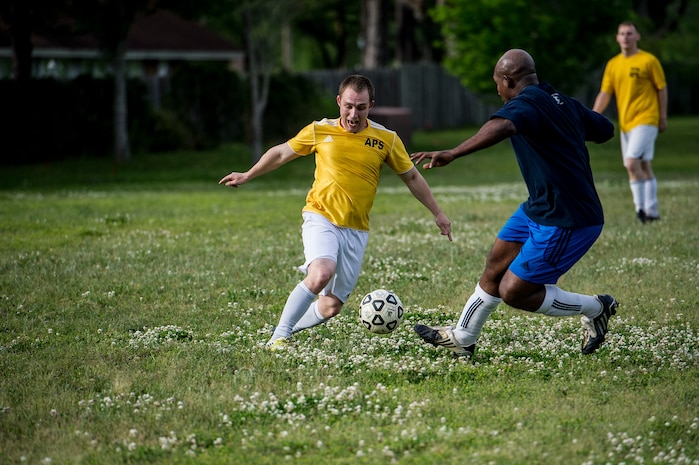 Senior Airman Jesse Ritz, 437th Aerial Port Squadron intramural soccer team player, dribbles past Master Sgt. Andred Jackson, 628th Logistics Readiness Squadron intramural soccer team defender May 2, 2013, at Joint Base Charleston – Air Base, S.C. The 628th LRS soccer team defeated the 437th APS soccer team 8 – 2 in Joint Base Charleston’s 2013 intramural soccer championship game. (U.S. Air force photo/Staff Sgt. Rasheen Douglas)