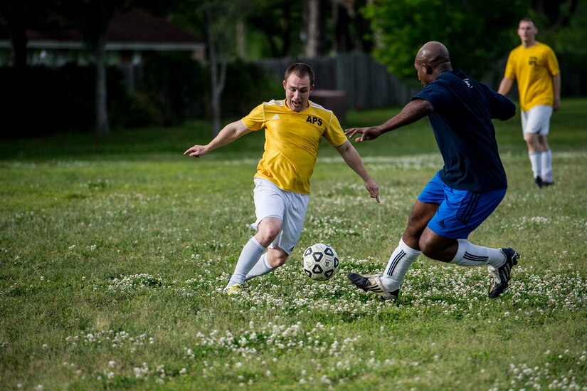 Senior Airman Jesse Ritz, 437th Aerial Port Squadron intramural soccer team player, dribbles past Master Sgt. Andred Jackson, 628th Logistics Readiness Squadron intramural soccer team defender May 2, 2013, at Joint Base Charleston – Air Base, S.C. The 628th LRS soccer team defeated the 437th APS soccer team 8 – 2 in Joint Base Charleston’s 2013 intramural soccer championship game. (U.S. Air force photo/Staff Sgt. Rasheen Douglas)