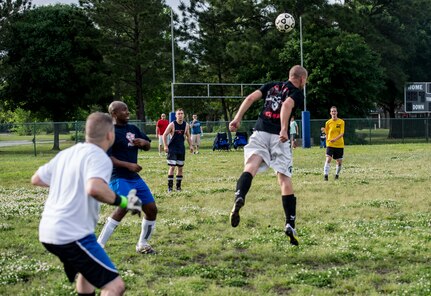 Airman 1st Class Kyle Jones, 628th Logistics Readiness Squadron intramural soccer team player, heads a soccer ball to keep possession away from the 437th Aerial Port Squadron intramural soccer team May 2, 2013, at Joint Base Charleston – Air Base, S.C. The 628th LRS soccer team defeated the 437th APS soccer team 8 – 2 in Joint Base Charleston’s 2013 intramural soccer championship game. (U.S. Air Force photo/Staff Sgt. Rasheen Douglas)