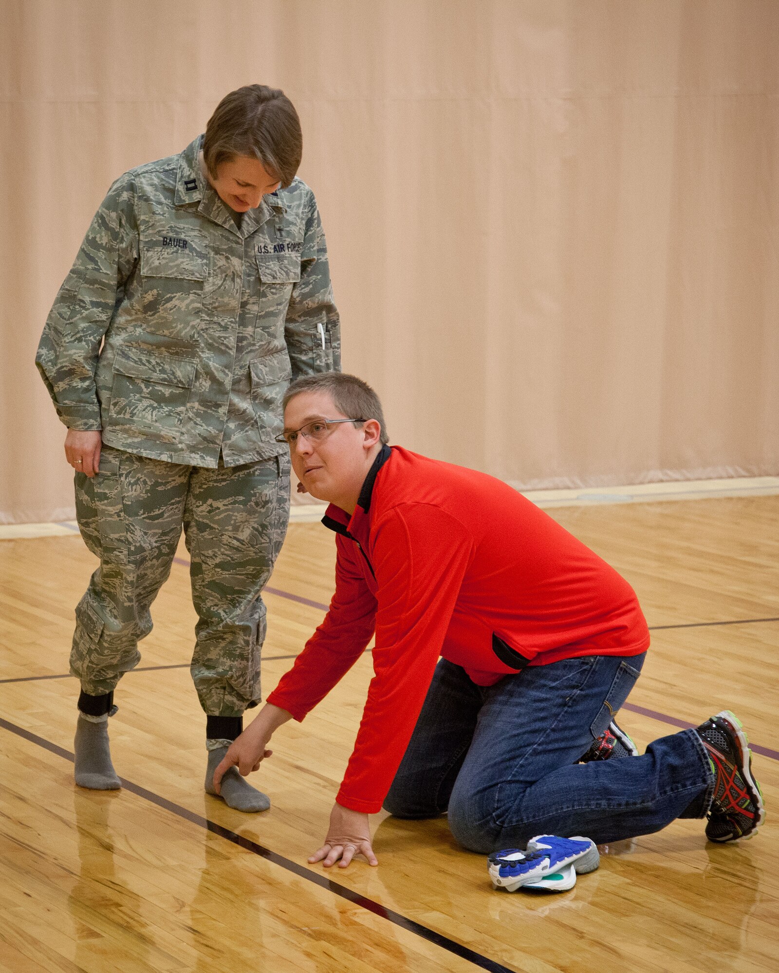 Chaplain (Cpt.) Tara Bauer, 934th Airlift WIng, helps Dan Steinbrecher, TCRunning Company, demonstrate how to determine your arch type during a running clinic at the 934th Airlift Wing Fitness Center.  The clinic covered advice and answered questions about common running problems, foot types, finding the correct shoe, and more during the May Unit Training Assembly weekend at the Minneapolis-St. Paul Air Reserve Station, Minn.  (U.S. Air Force photo/Shannon McKay)