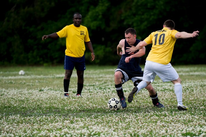 Capt. Kent Germaine (black shirt), 628th Logistics Readiness Squadron intramural soccer team player, dribbles past Senior Airman Jesse Ritz, 437th Aerial Port Squadron intramural soccer team defender May 2, 2013, at Joint Base Charleston – Air Base, S.C.. The 628th LRS soccer team defeated the 437th APS soccer team 8 – 2 win in Joint Base Charleston’s 2013 intramural soccer championship game. (U.S. Air Force photo/Staff Sgt. Rasheen Douglas)