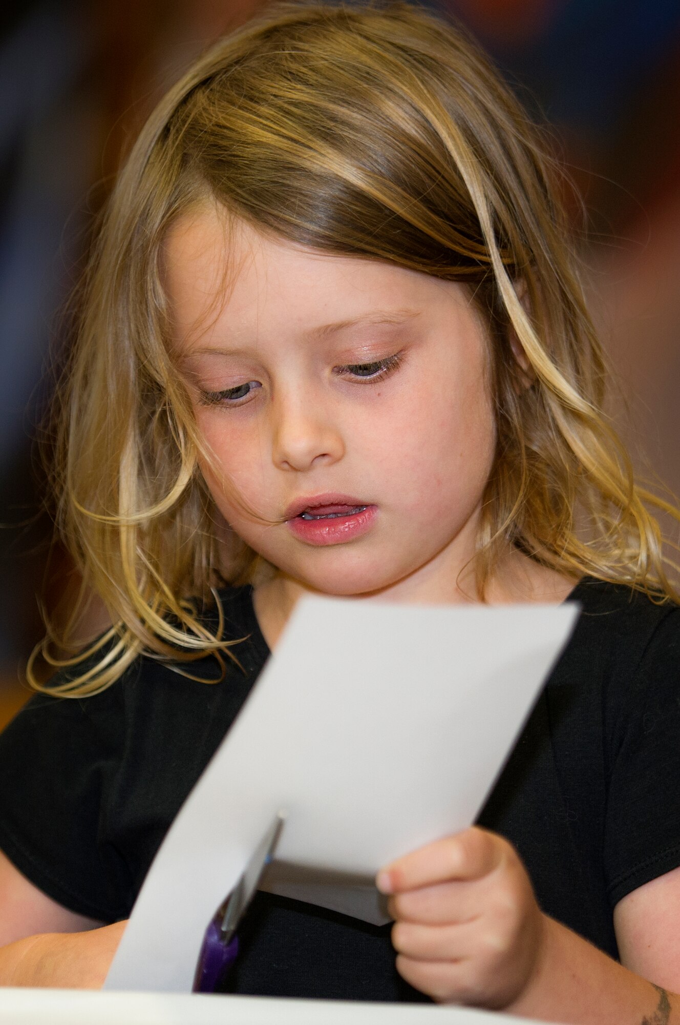 Hannah, daughter of Krissy Lunsford, a Hurlburt Field spouse, cuts a piece of paper during a “See you Soon” event held by the Military Child Education Coalition’s Student 2 Student program at the Fort Walton Beach High School gymnasium at Fort Walton Beach, Fla., May 2, 2013. The focus of the event was to provide free food and a break to the spouses of deployed military members. (U.S. Air Force photo/Airman 1st Class Christopher) 