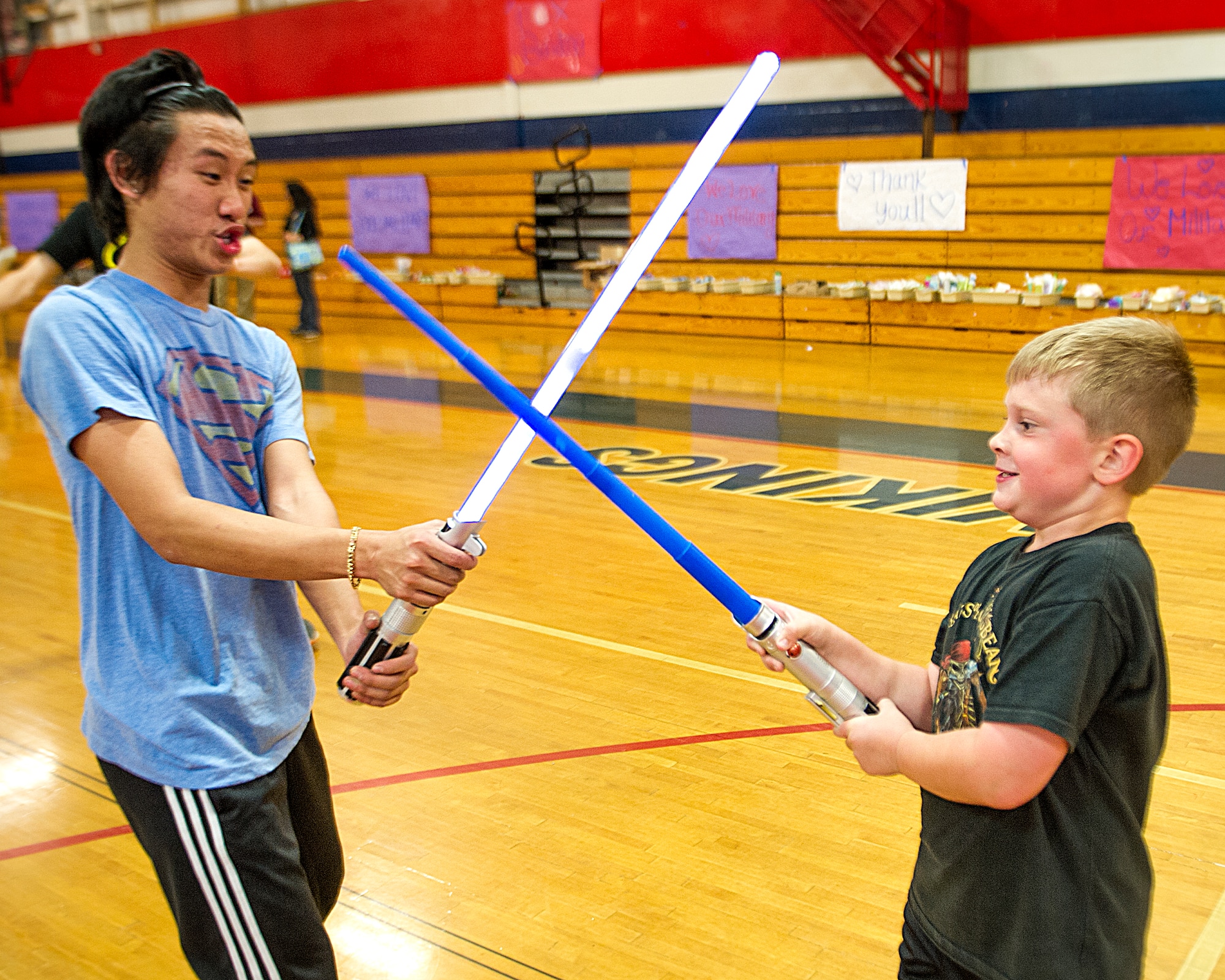 Chase, son of Angela Kessler, a Hurlburt Field spouse, has a mock light saber fight with one of the Military Child Education Coalition’s Student 2 Student program members at the Fort Walton Beach High School gymnasium at Fort Walton Beach, Fla., May 2, 2013. The S2S program held a “See You Soon” event offering a special night for families of deployed Hurlburt members to fill boxed for their deployed loved ones. (U.S. Air Force photo/Airman 1st Class Christopher Callaway) 