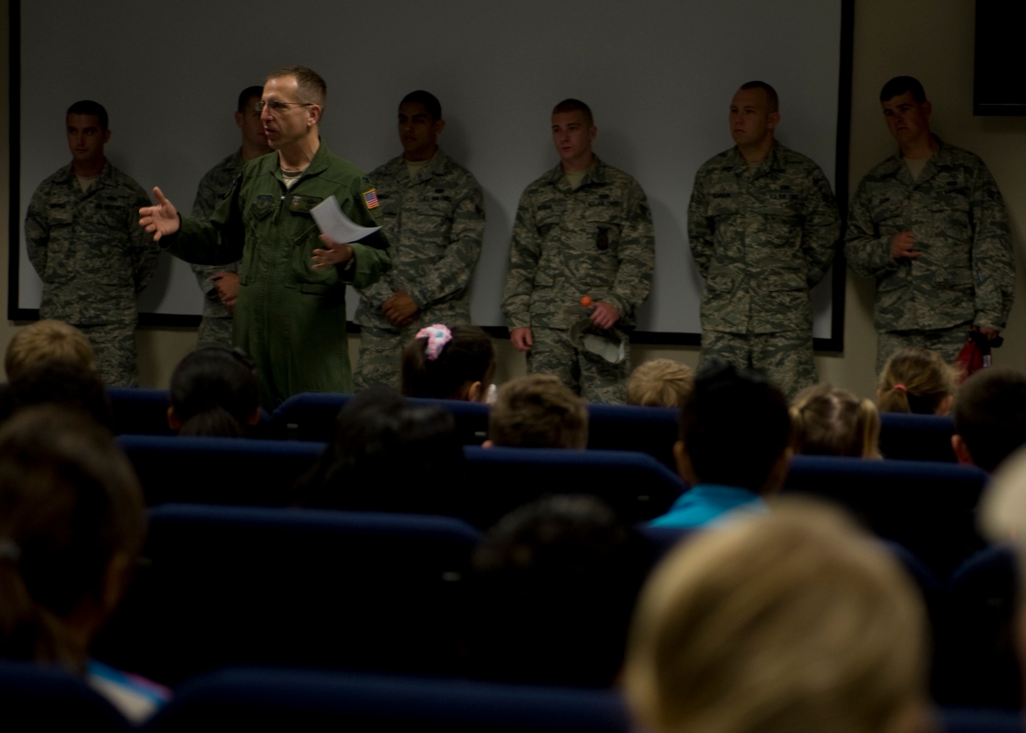 Col. Jim Slife, commander of 1st Special Operations Wing, addresses children participating in the Kids Understand Deployment Operations event at the Deployment Control Center auditorium on Hurlburt Field, Fla., April 27, 2013.  This is the first step before participating in various activities to mimick the steps military members take before deploying.  (U.S. Air Force photo by Airman 1st Class Hayden K. Hyatt)