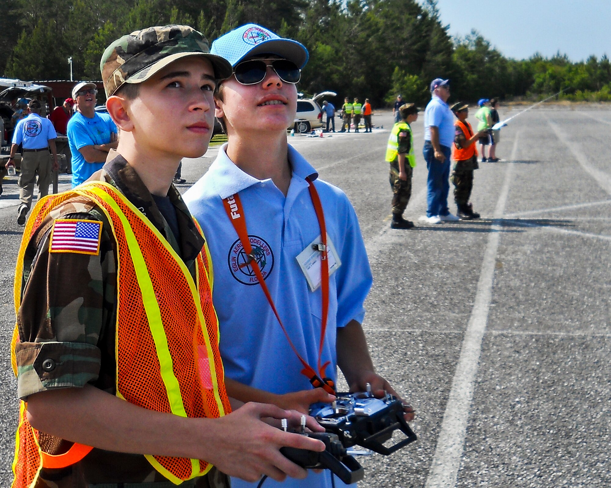 Cody Powell, the 13-year-old son of Maj. Jeff Powell, the 919th Maintenance Operations Flight commander, helps a member of Eglin's Civil Air Patrol learn to fly an radio controlled aircraft April 27. Cody has won all but one of his 15 RC aircraft competitions since he and his father joined the hobby two years ago. (Courtesy photo)